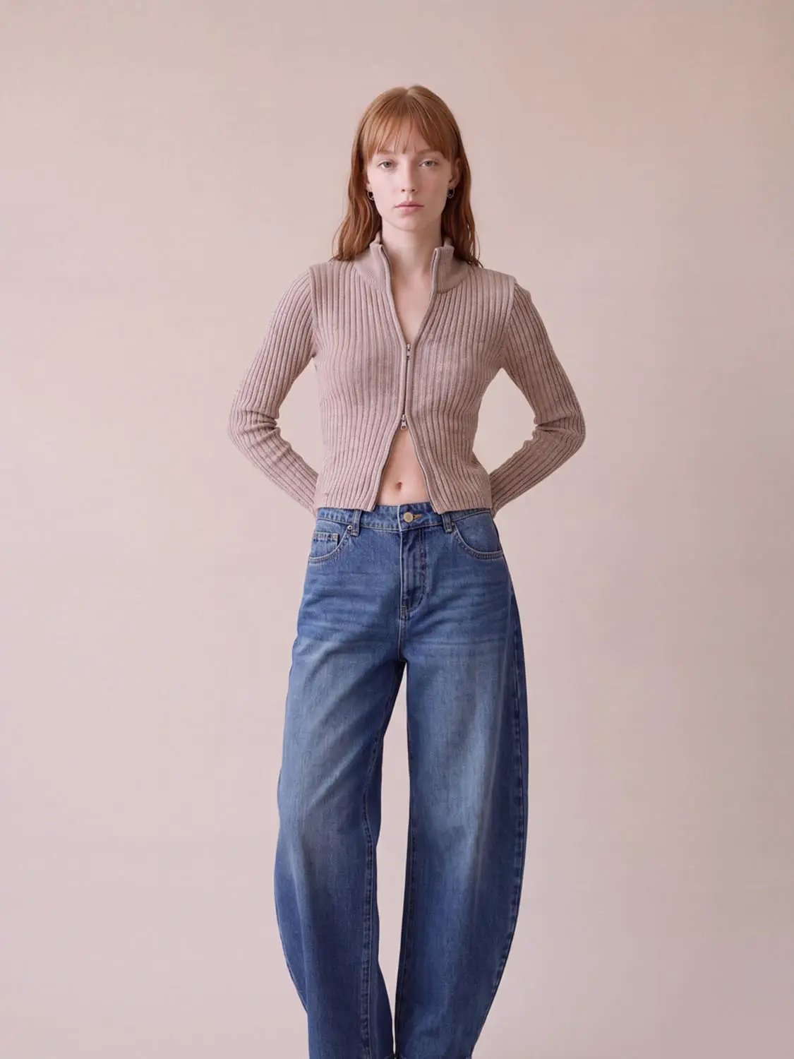Jeans in blue denim with a wide-leg fit; model wears them for product shot