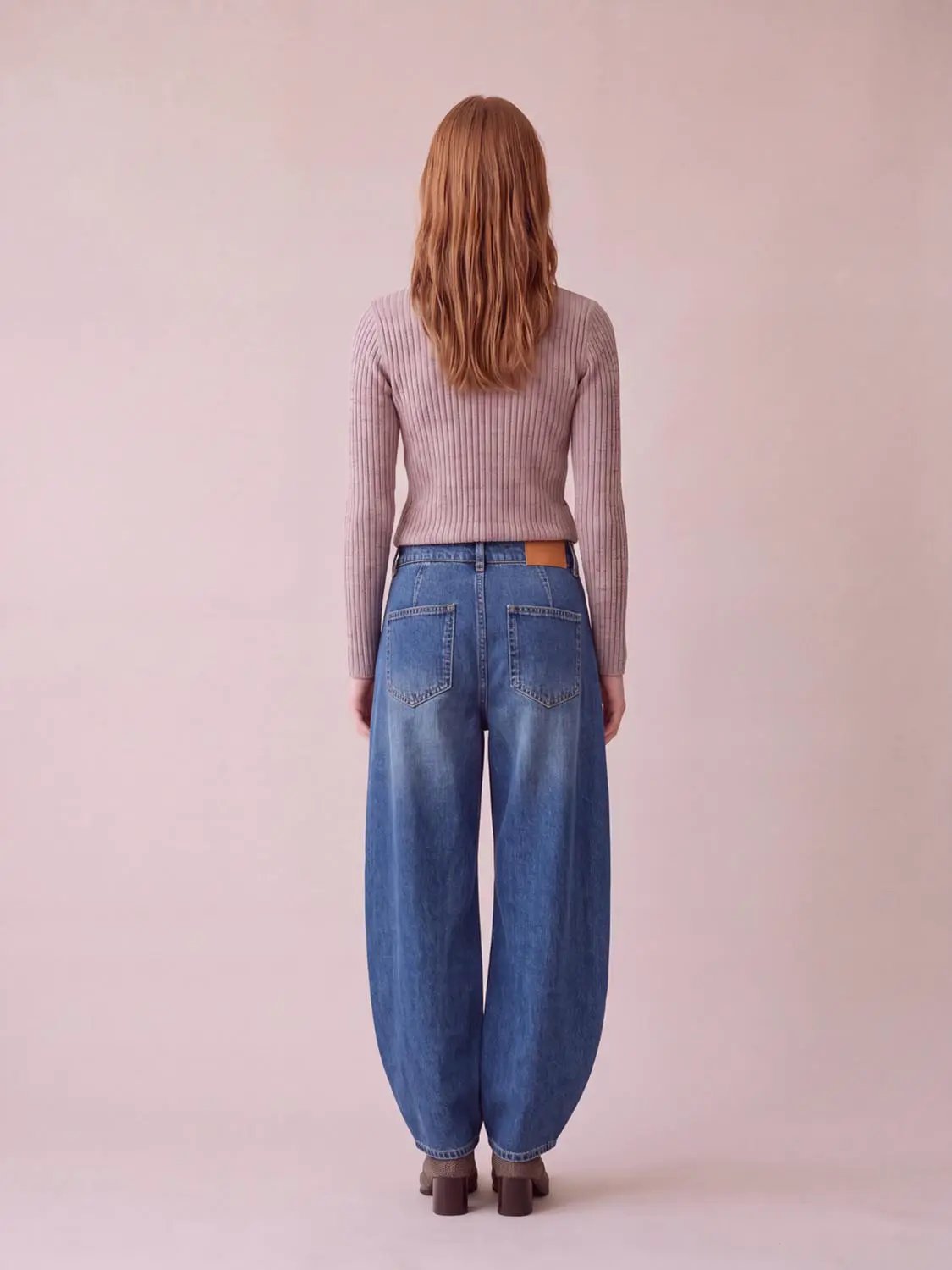 Jeans, blue denim wide-leg back view with rear pockets and brown leather patch.