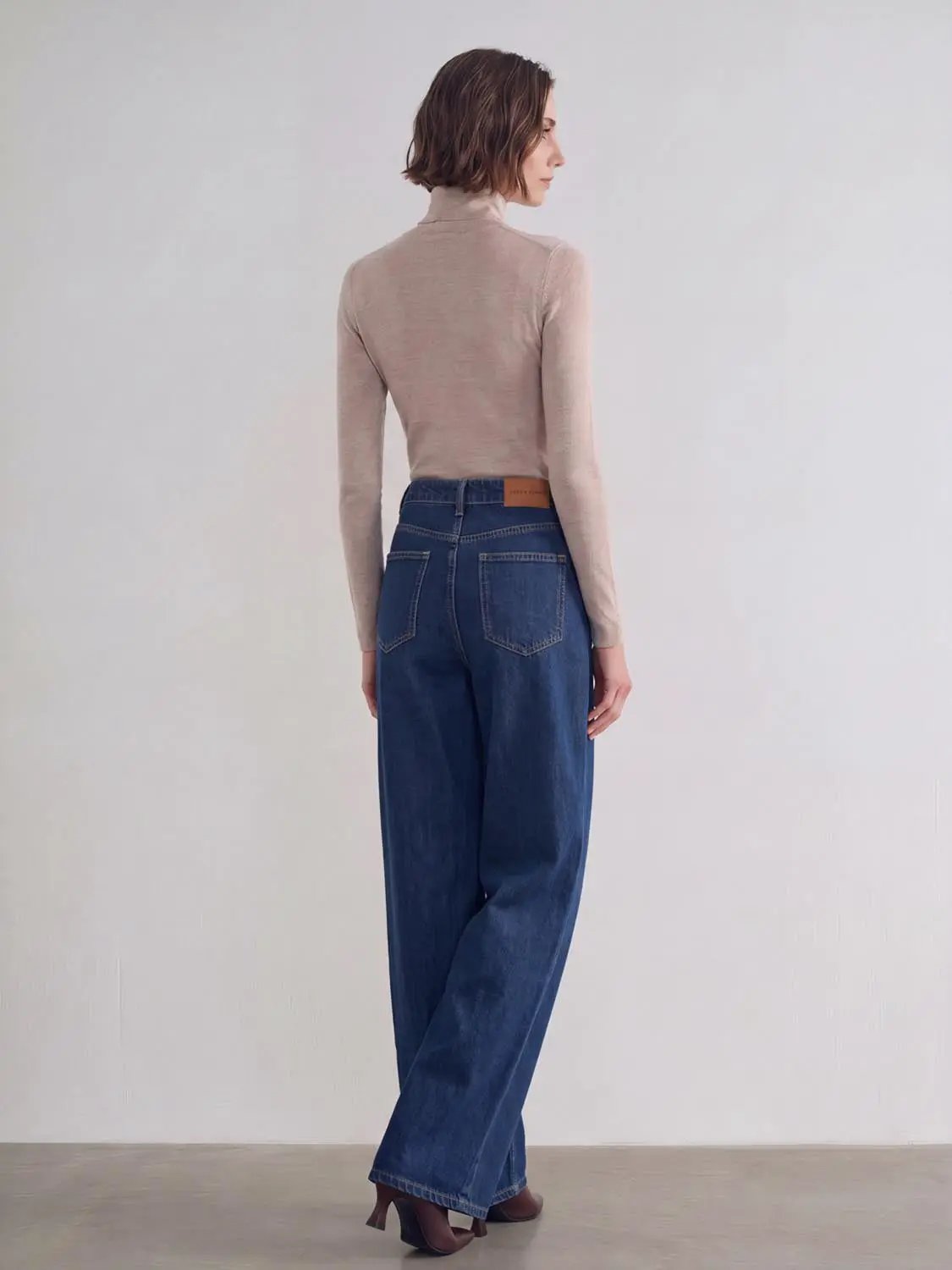 Jeans by Urban Revivo Fashion; blue wide-leg denim with back pockets and brown leather logo patch.