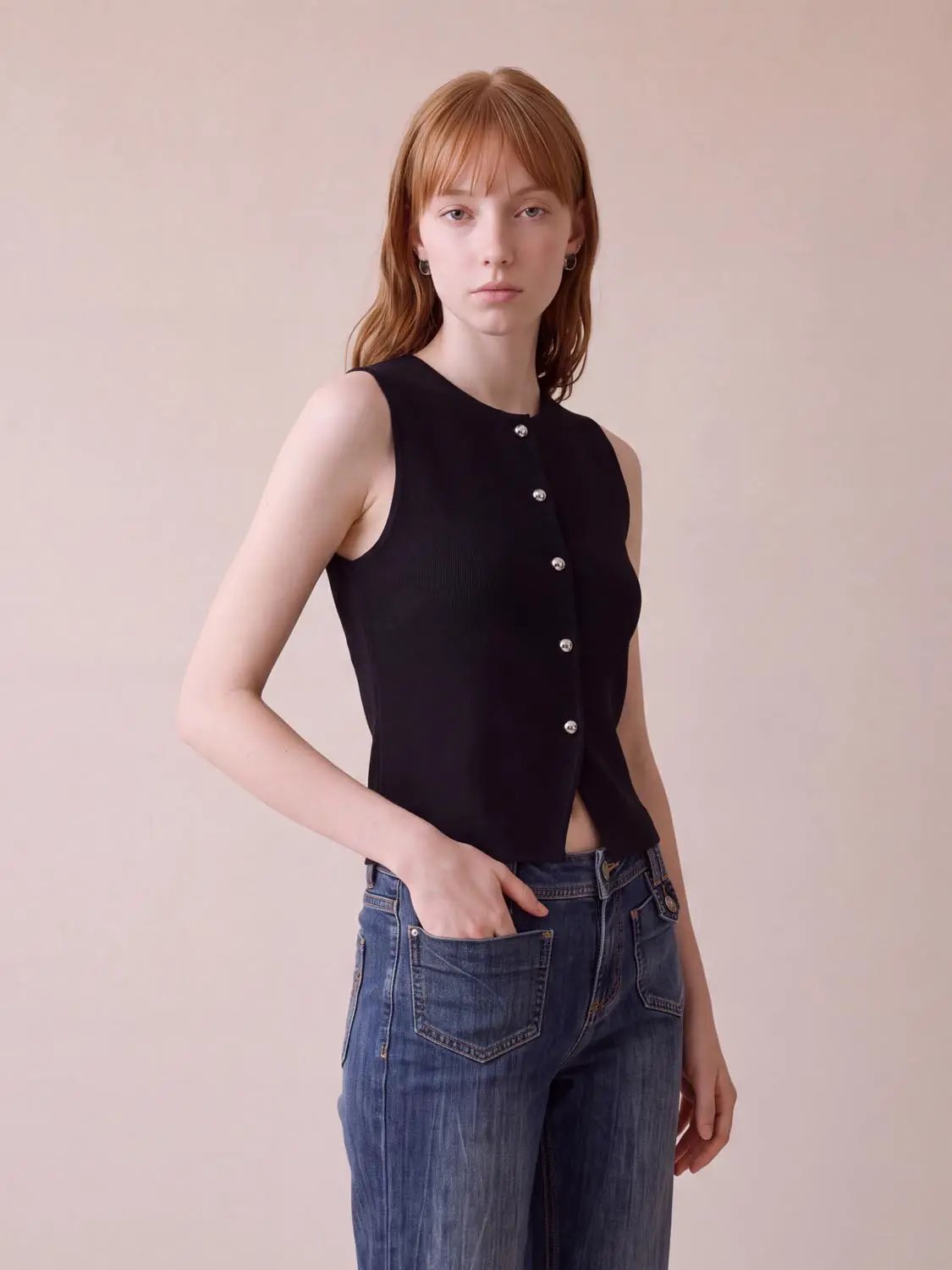 Round-neck button-front sleeveless cropped knit vest in black with silver buttons