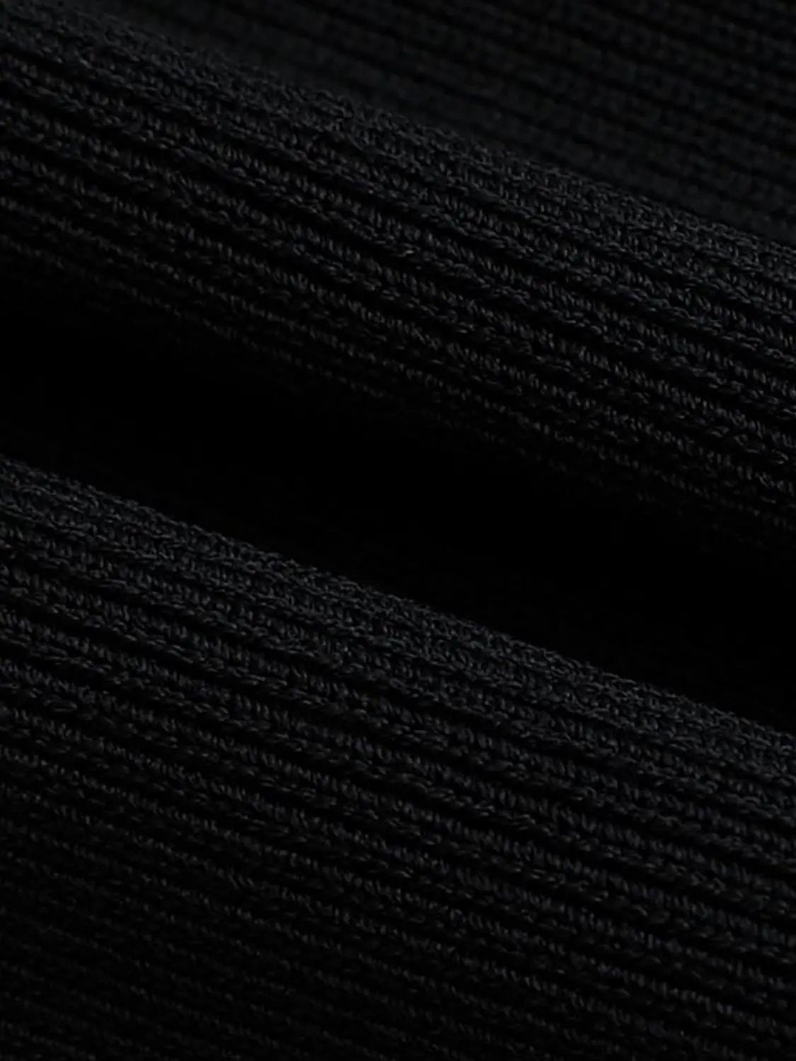 Round neck sleeveless cropped knit vest in black fabric close-up knit texture