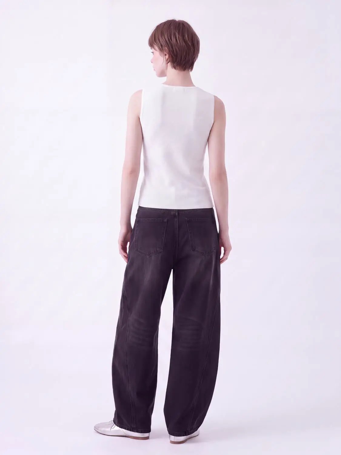 Round Neck Button Front Sleeveless Cropped Knit Vest in white, shown on model with dark pants.