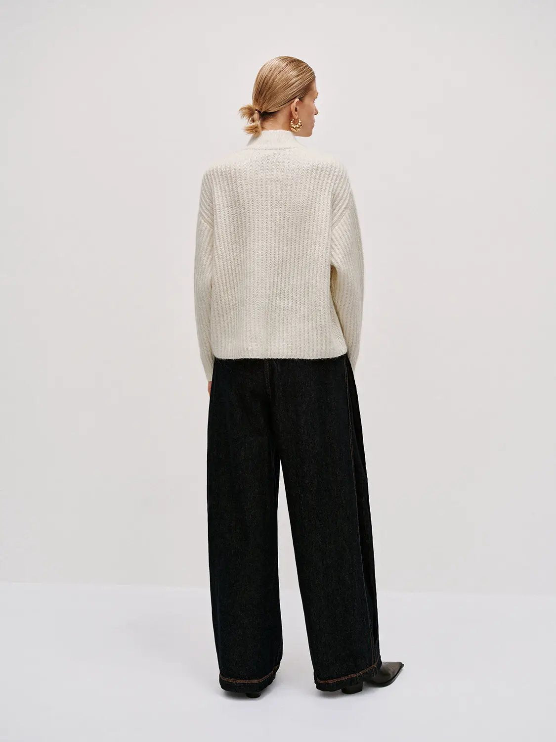 High neck long sleeve knitted t-shirts in cream; model wears it with dark wide-leg jeans, Urban Revivo Fashion.