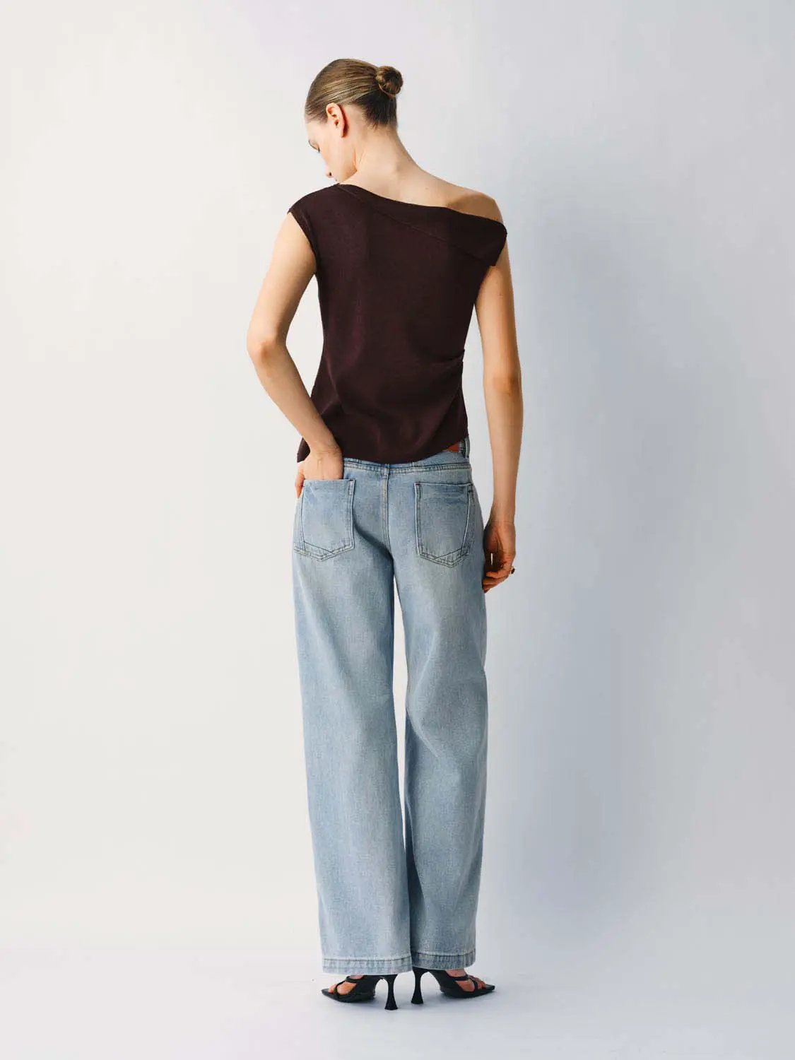Medium Stretch T-Shirt in burgundy knit worn by a model with light-wash denim jeans, back view.
