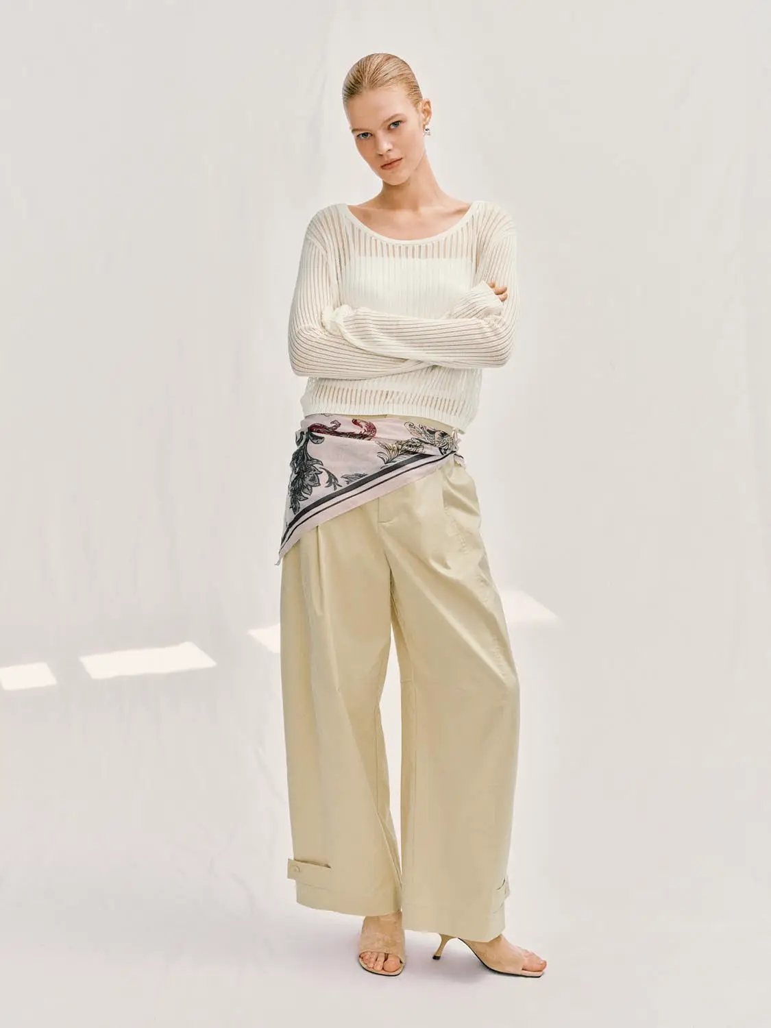 Knit T-Shirt in cream, paired with beige wide-leg pants.