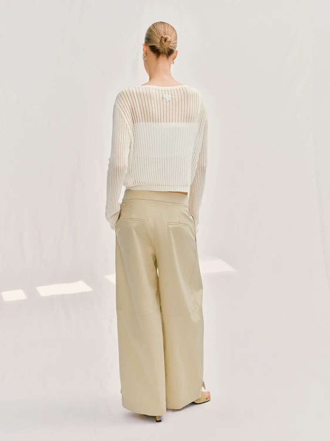 Knit T-Shirt in ivory with sheer ribbed knit texture, paired with beige wide-leg pants