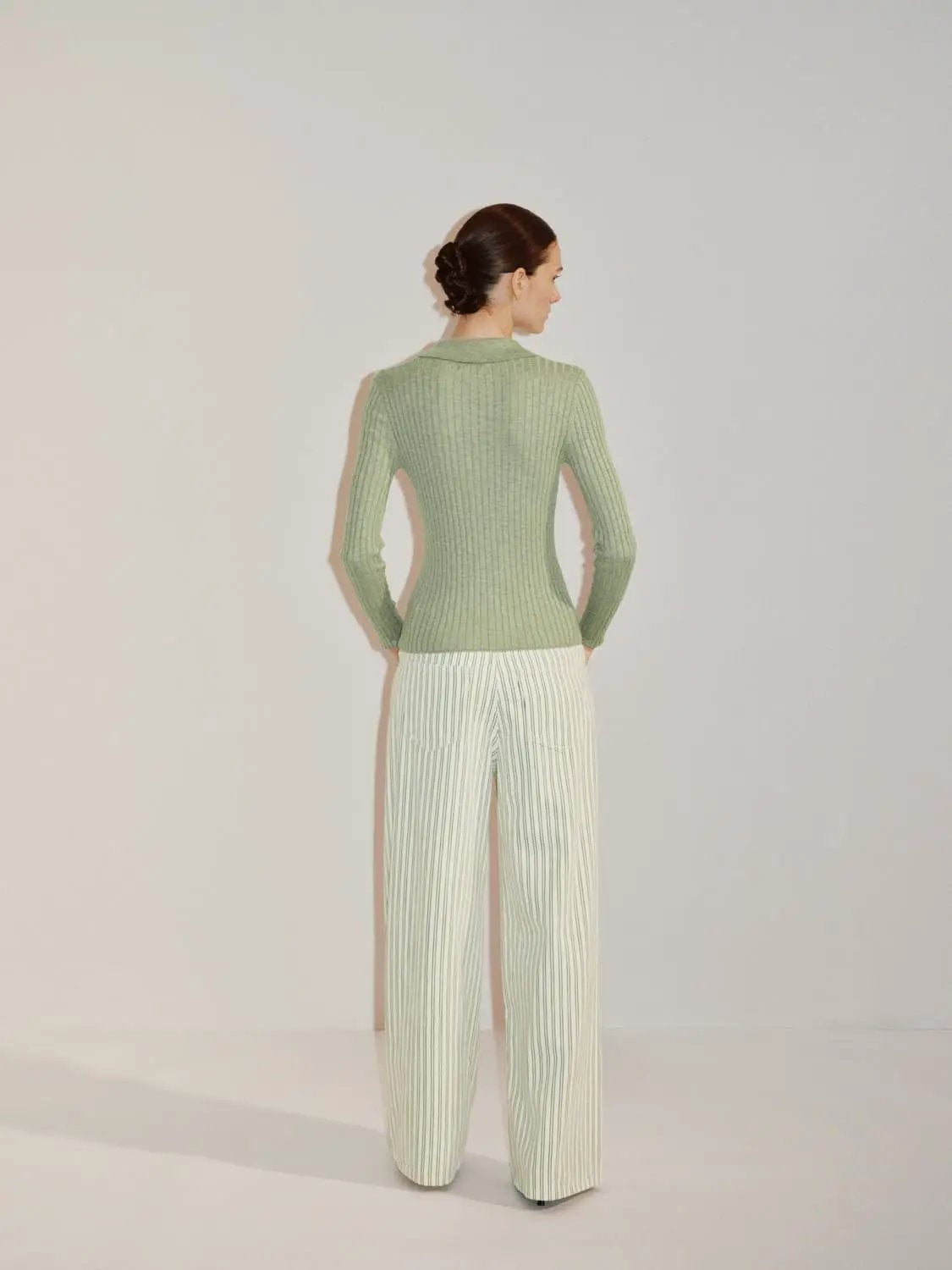 Ribbed cotton-blend shirt-collar cardigan in sage green, worn by model with pale green striped pants; Urban Revivo.