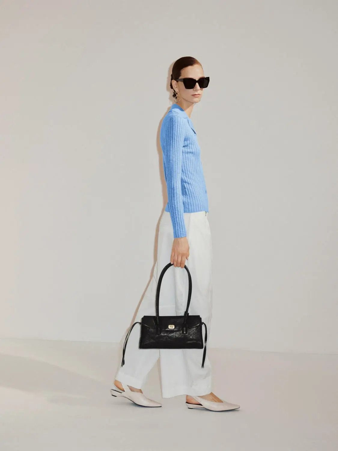Ribbed cotton-blend shirt-collar cardigan in light blue by Urban Revivo Fashion, paired with white wide-leg pants and a black handbag