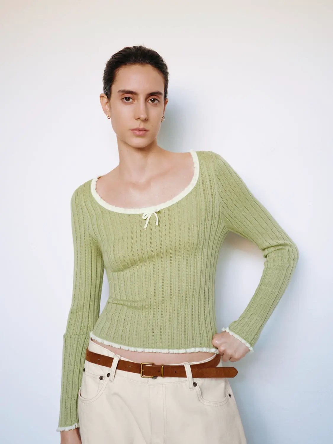Ribbed square-neck long-sleeve knit T-shirt in sage green with bow neckline, white trim, and raw hem