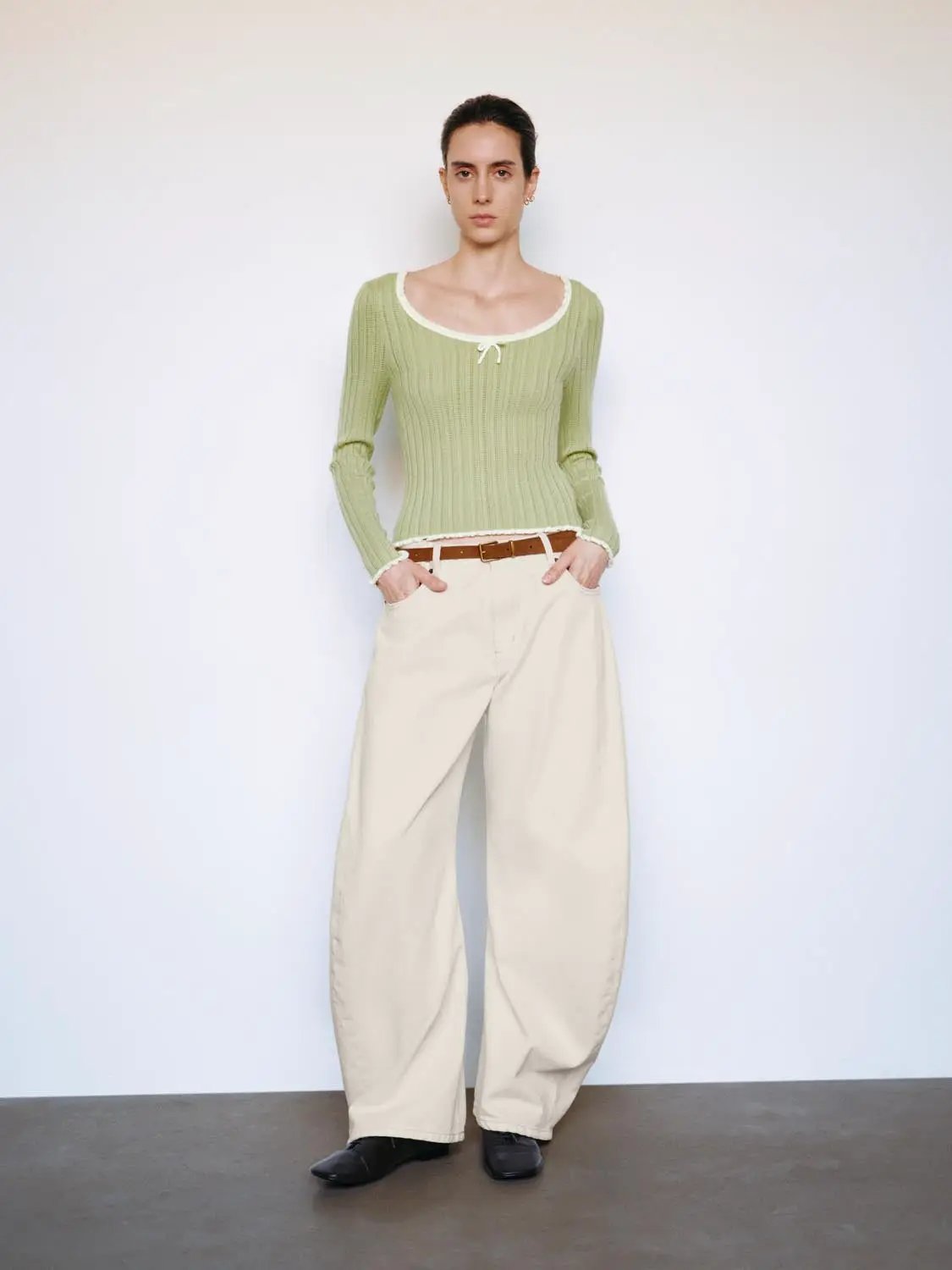 Ribbed square-neck long-sleeve knit top in light green with white bow and frayed hem