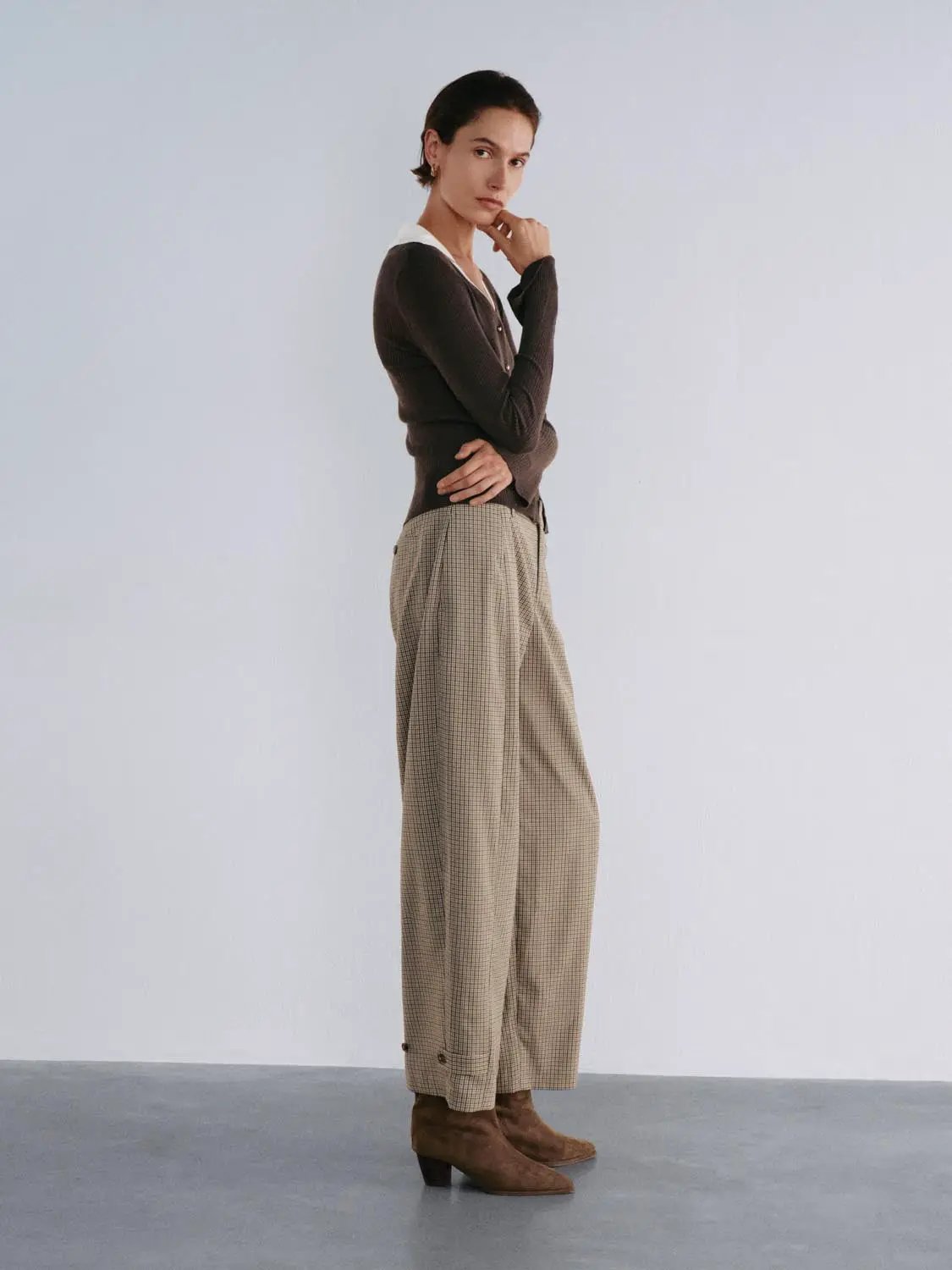 Knit cardigan by Urban Revivo Fashion in brown, worn with beige checkered trousers.