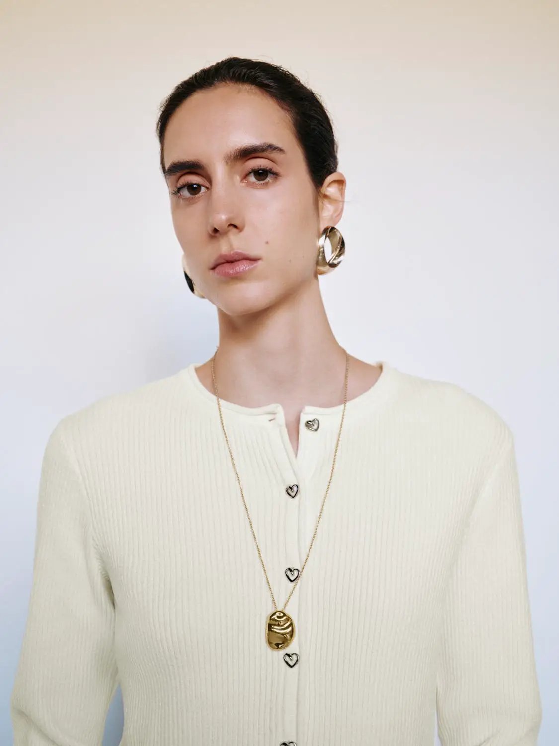 Ribbed heart-button crew-neck long-sleeve knitted cardigan in cream.