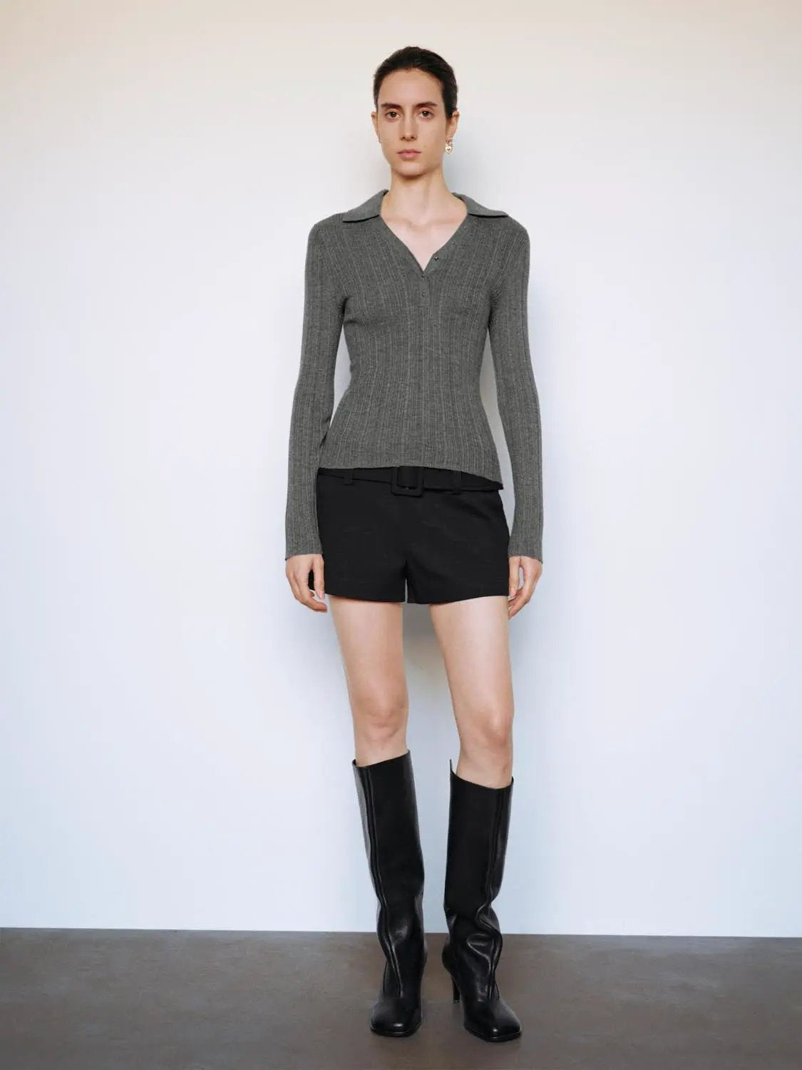 Ribbed Fitted Polo Collar Long Sleeve Sweater in gray on model, paired with black shorts and knee-high boots.