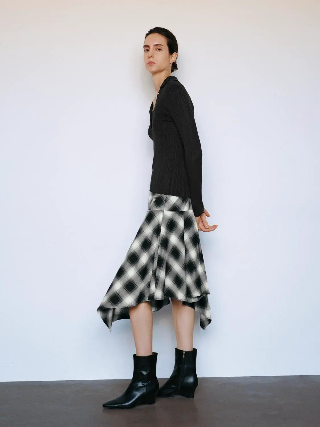 Ribbed fitted polo-collar long-sleeve sweater in black; 2-piece outfit with black-and-white plaid midi skirt