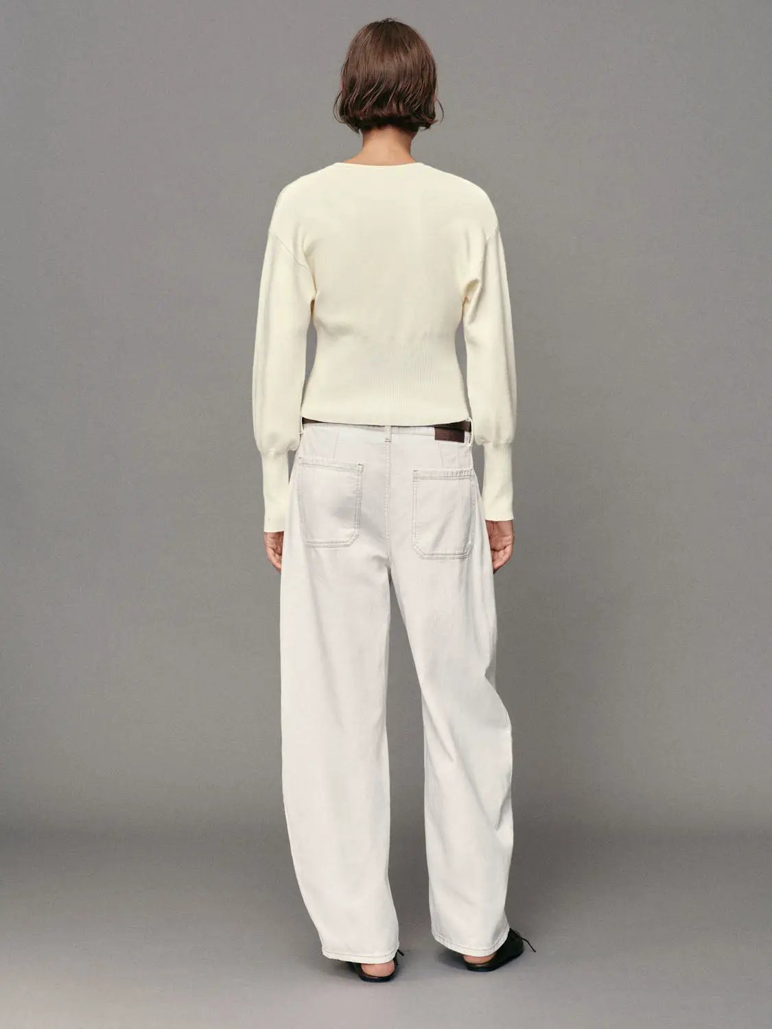 Ribbed button-front cardigan in cream knit with long sleeves and crew neck.