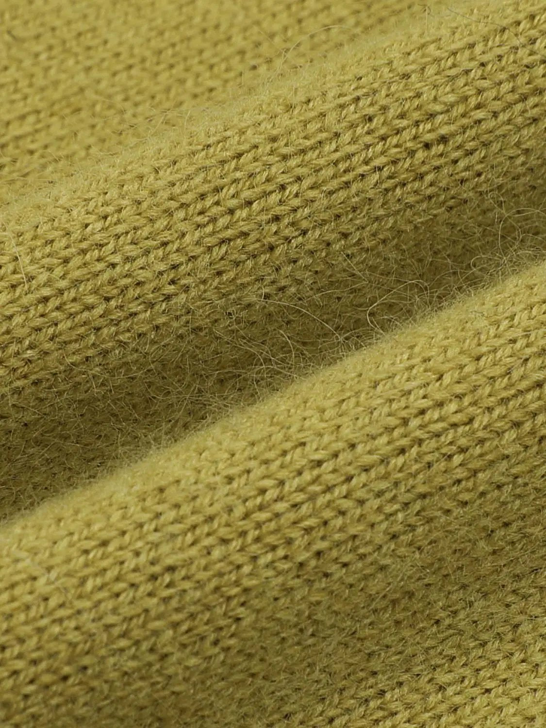 Knit T-Shirts knitted fabric in warm mustard yellow, close-up of fine textured knit.