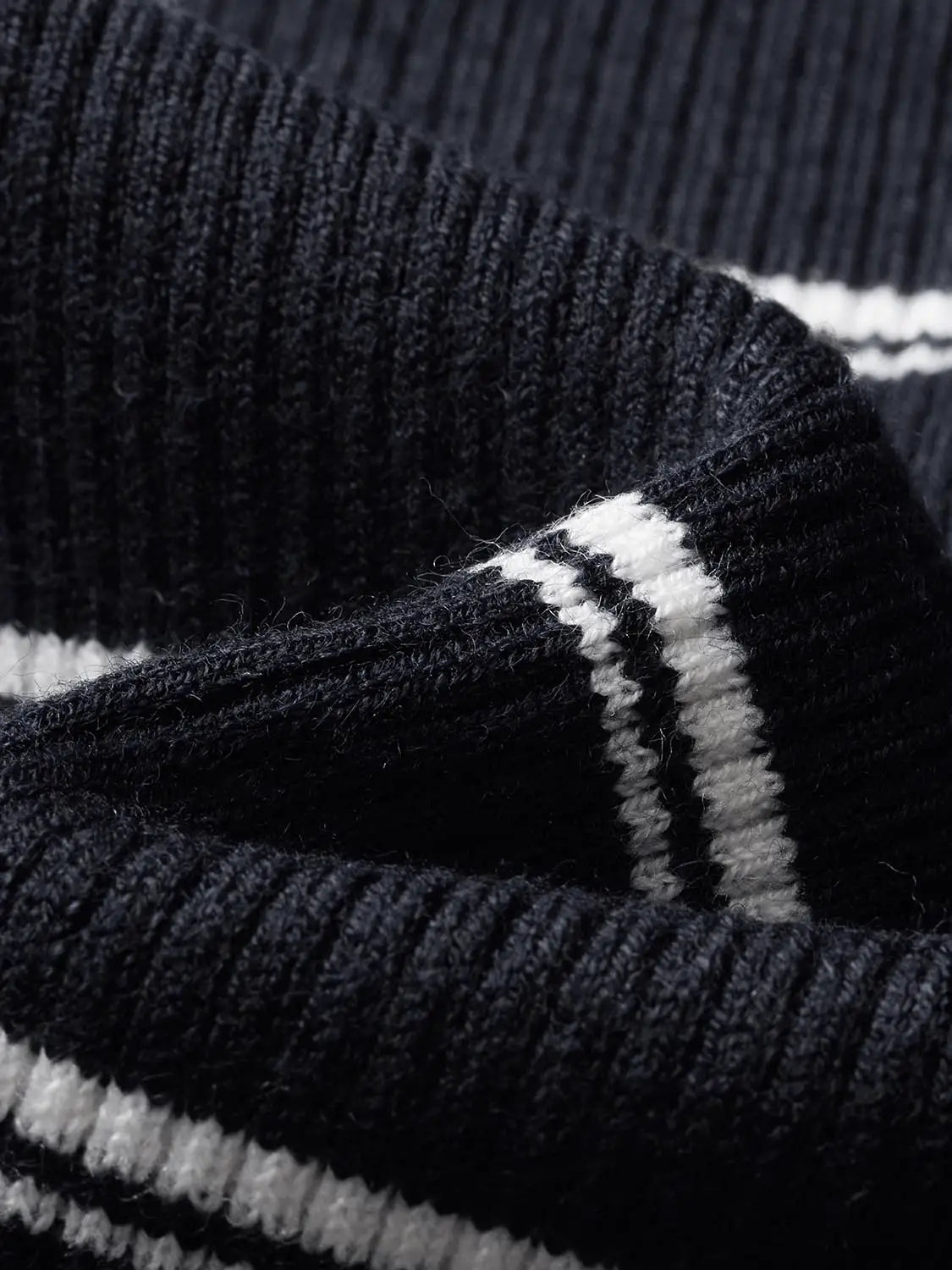 Knitted cardigan in navy with white stripe trim; ribbed knit detail.
