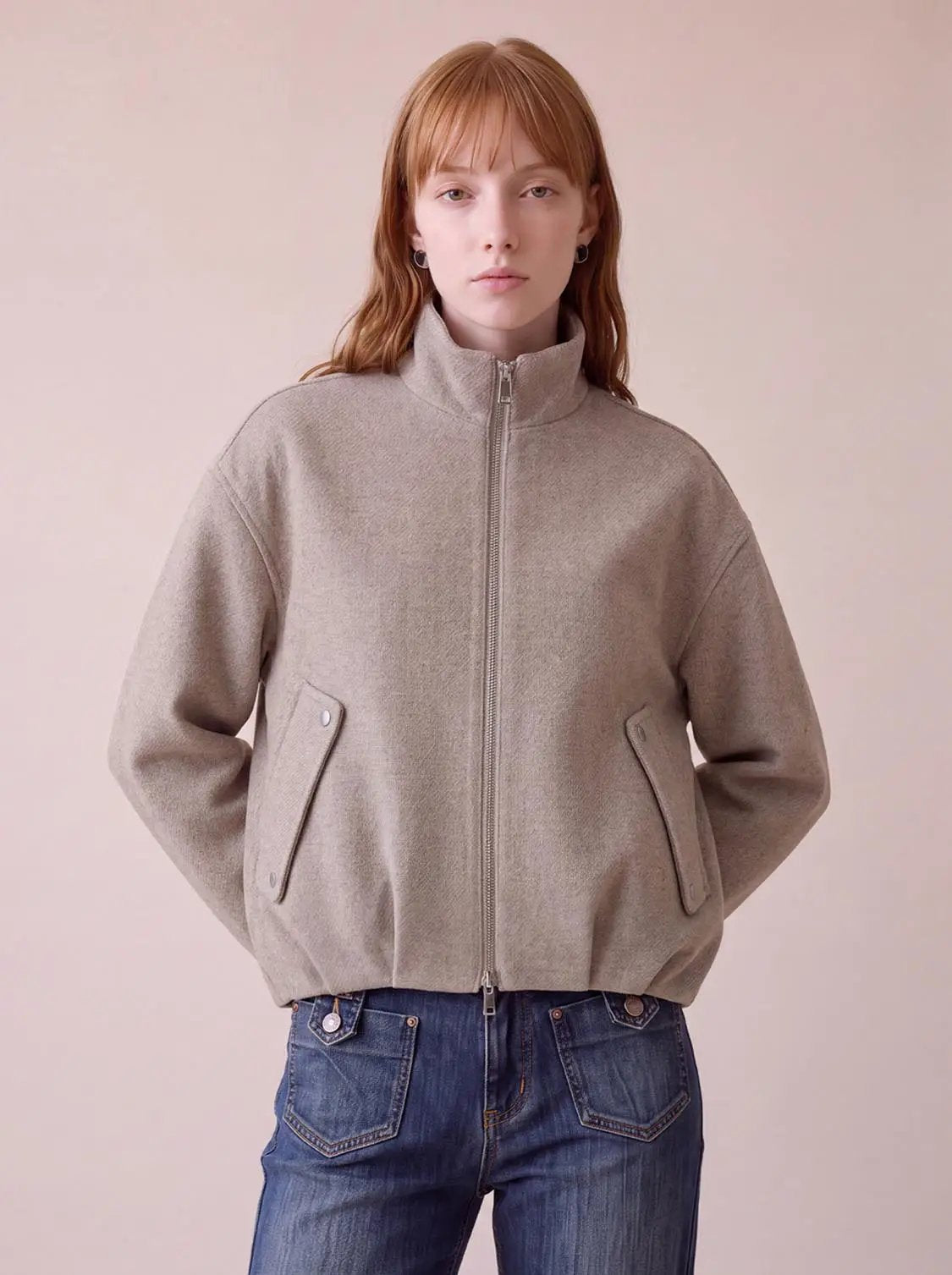 Funnel-neck thick jacket in beige with front zip and angled pocket flaps