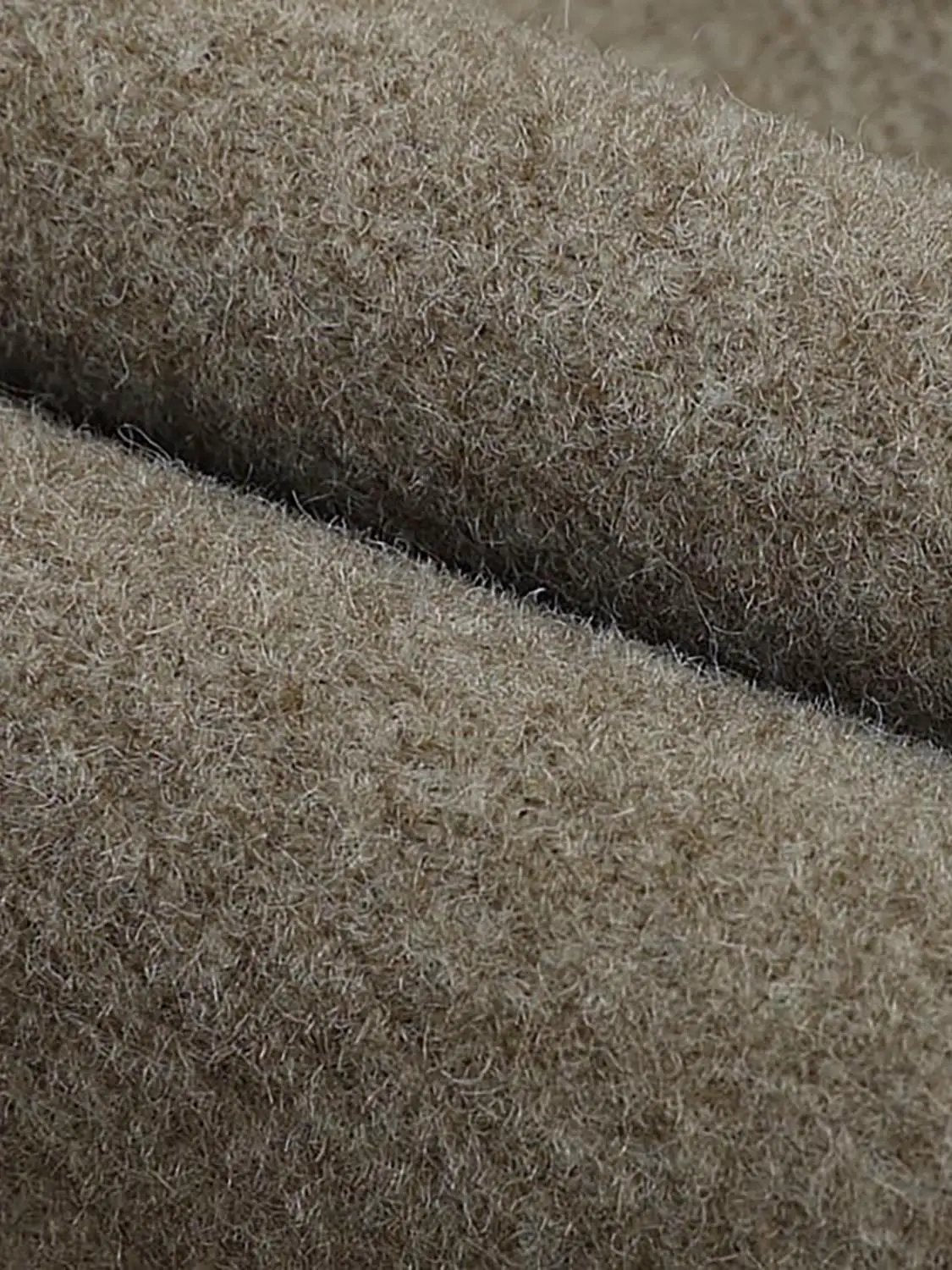 Funnel neck thick jacket close-up in beige-brown boucle fabric