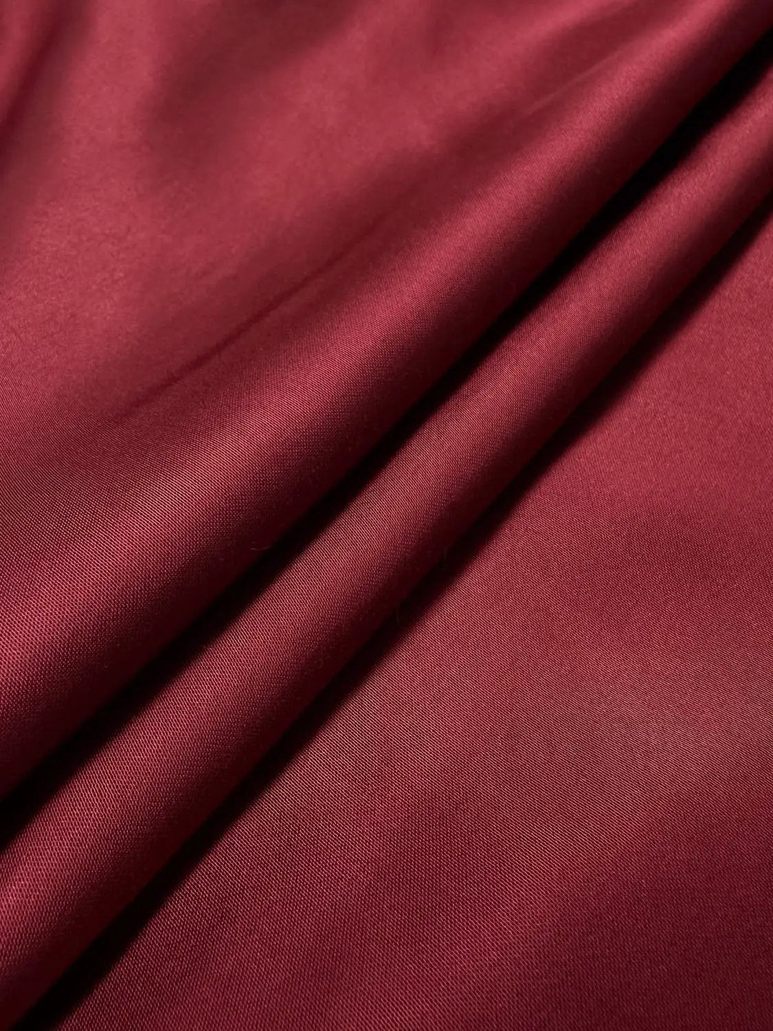 S-Line Dress close-up of deep red satin fabric with soft folds