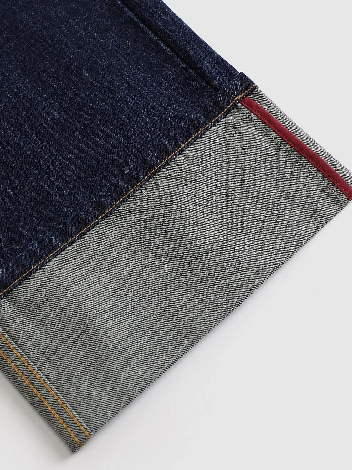 Jeans by Urban Revivo Fashion; dark indigo denim with a light denim panel and orange stitching, red edge trim.