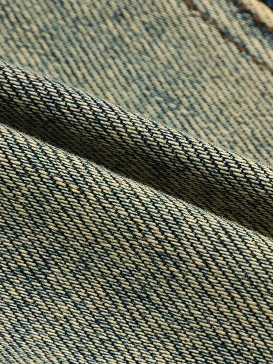 Long sleeve off-shoulder washed denim cropped top fabric close-up