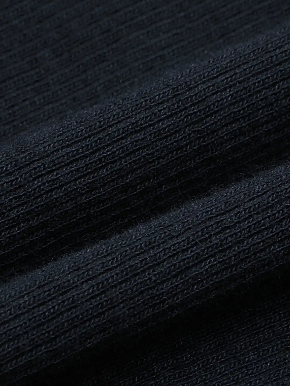 T-shirt fabric close-up in deep black cotton knit texture