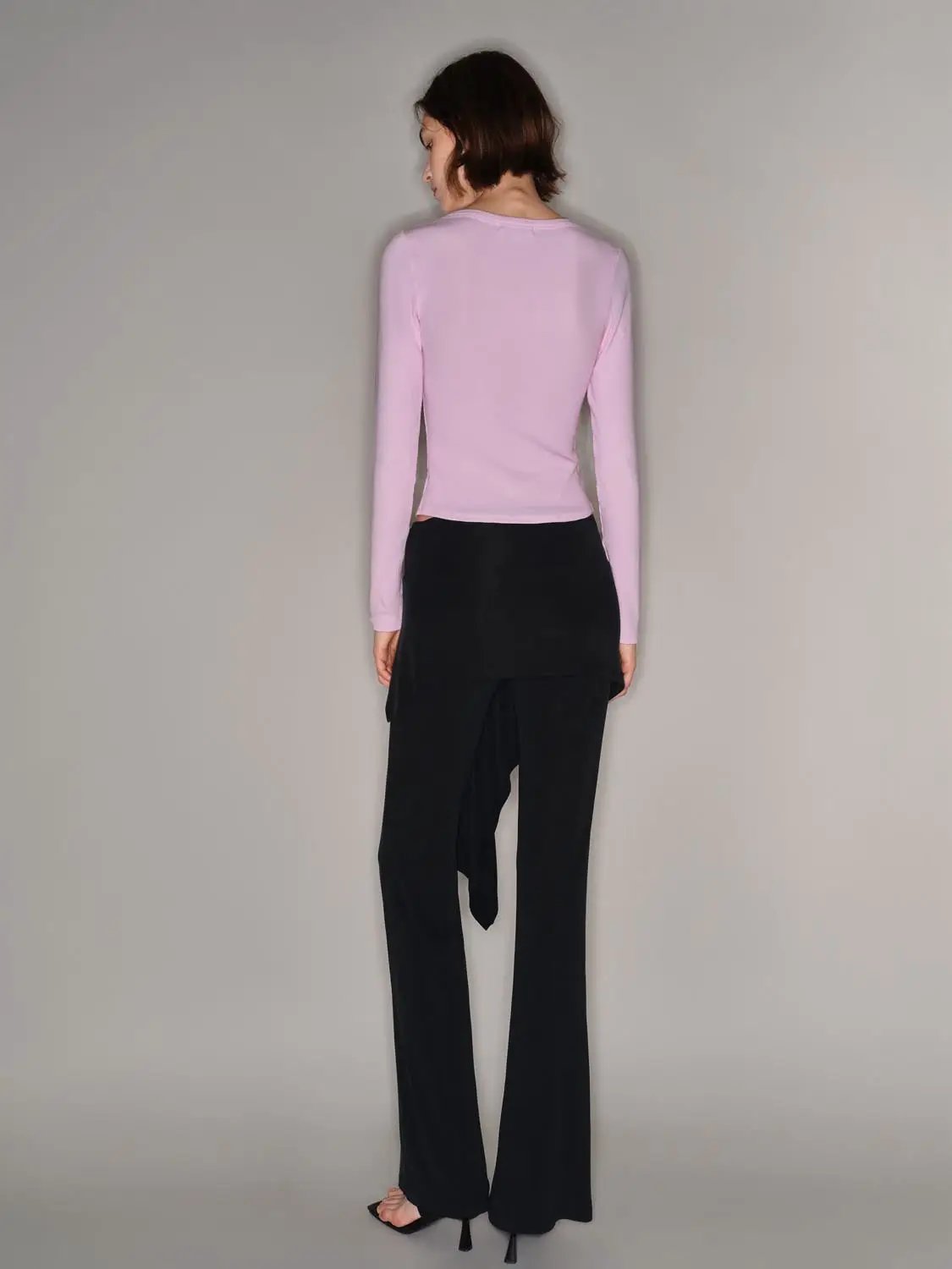 T-Shirt by Urban Revivo Fashion in pale pink, paired with black wide-leg pants on model