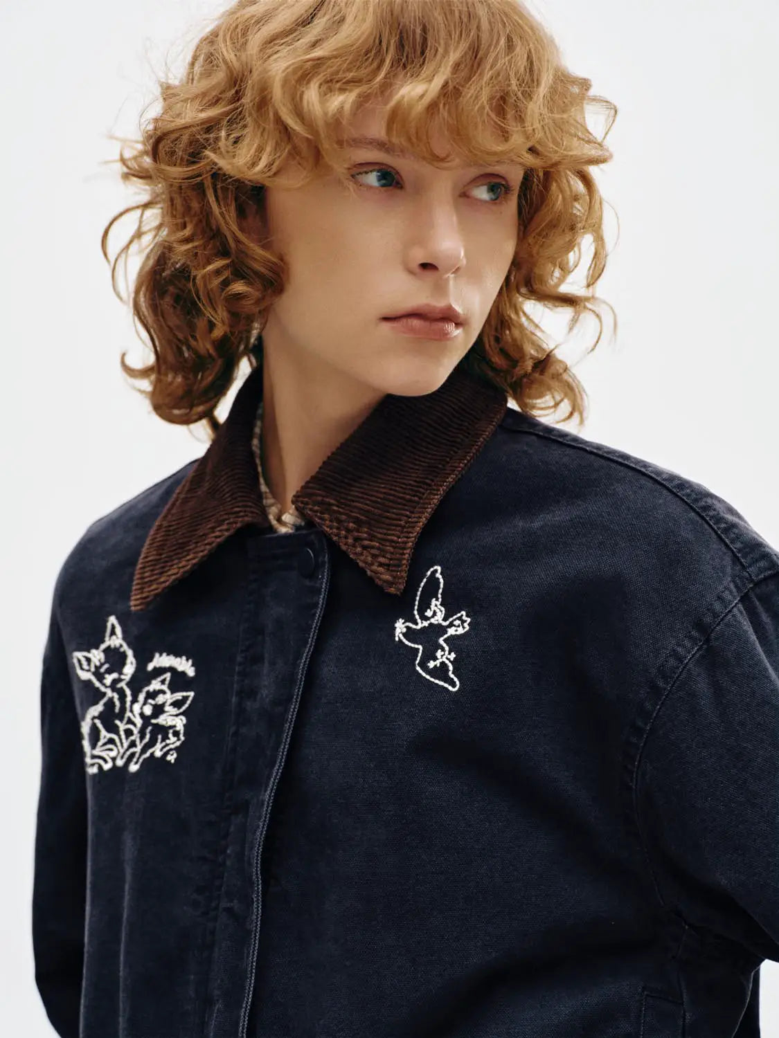Padded jacket by Urban Revivo in dark denim with brown corduroy collar and white embroidery.
