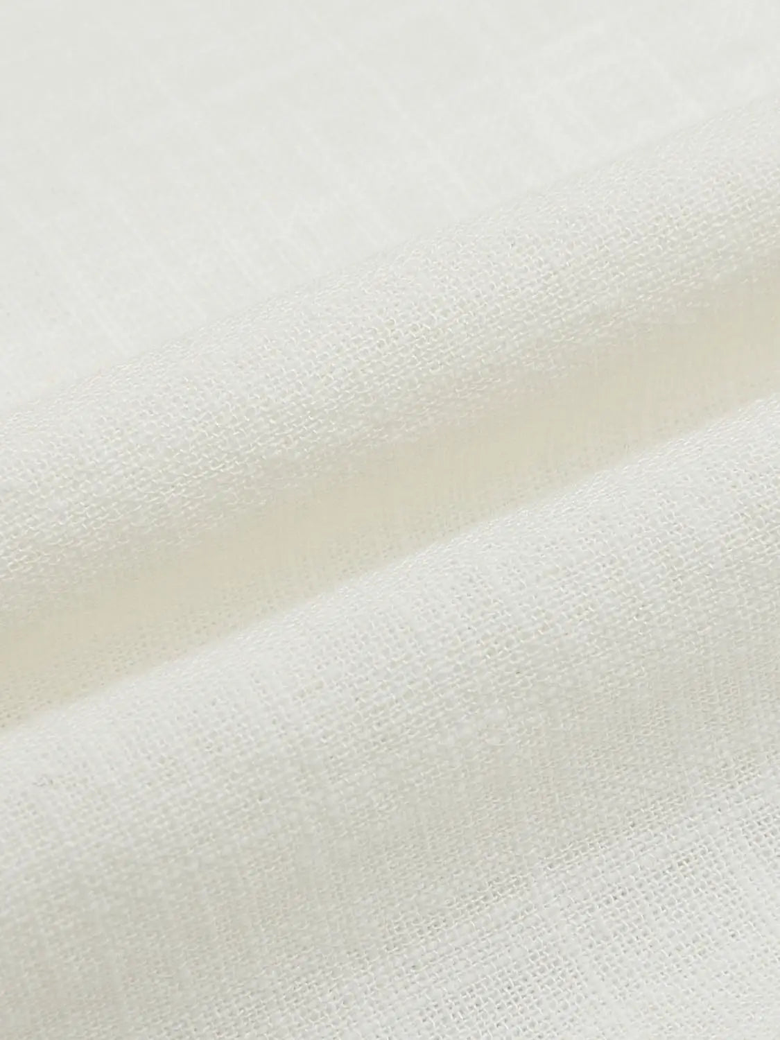 Blouse fabric close-up in white, plain woven textile with soft texture