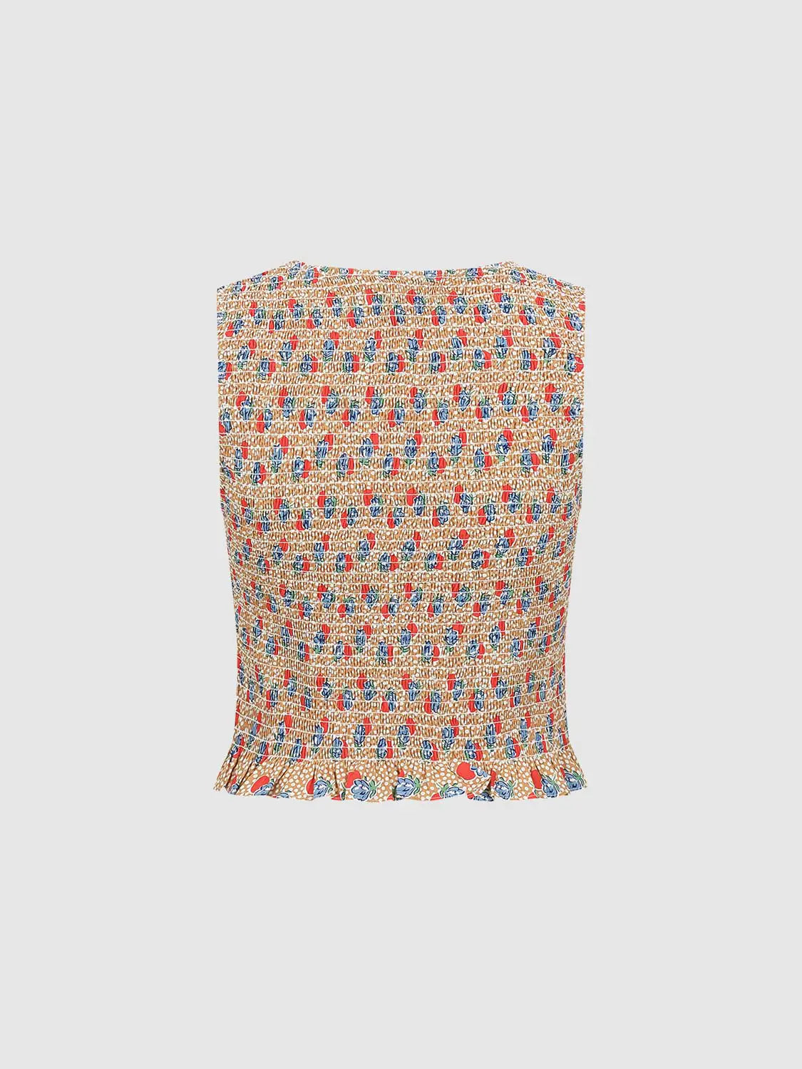 Blouse in orange-beige with multicolor print and a ruffled hem.