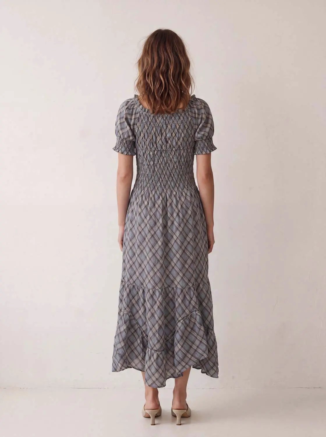A-Line dress in blue-gray plaid with a smocked bodice and puff sleeves, ankle-length.