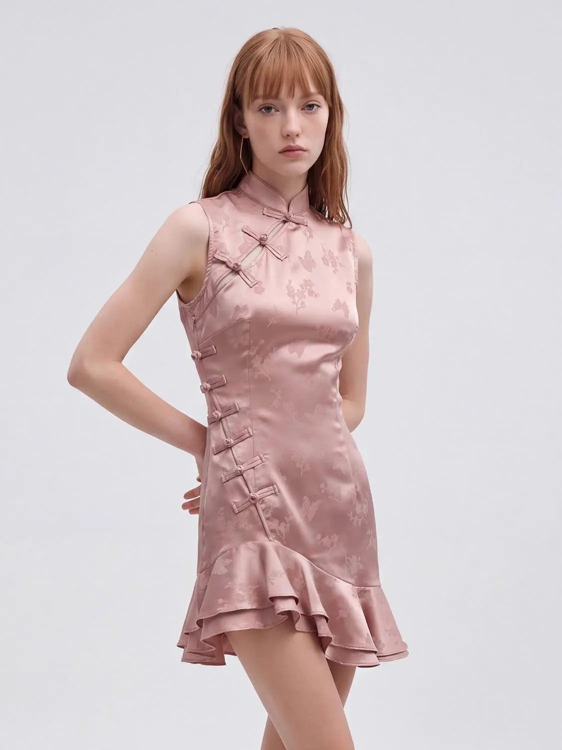 S-line Dress in blush pink satin with floral jacquard, slim-fit silhouette, frog closures, and ruffled hem
