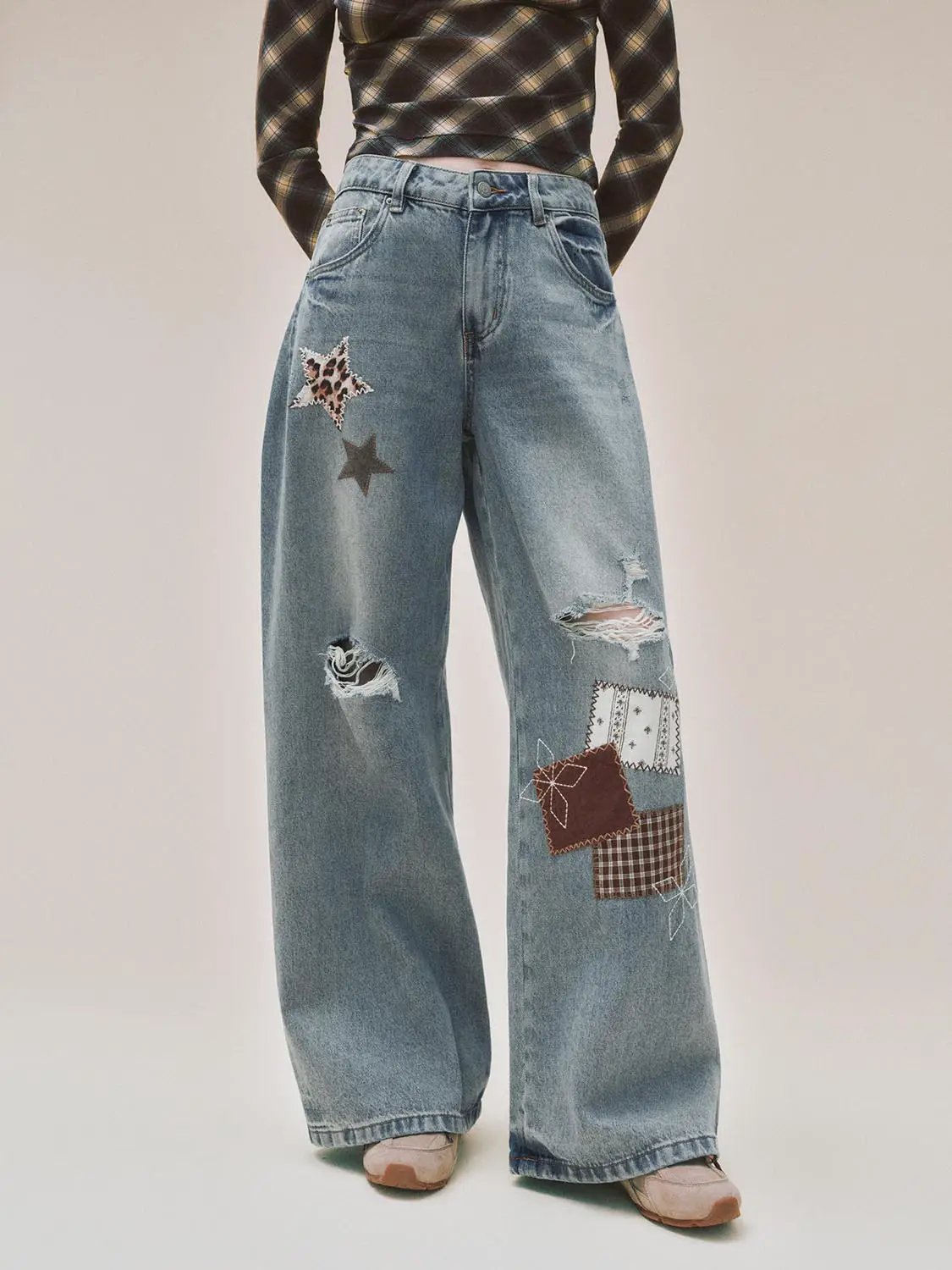 Patchwork Ripped Wide-leg Low-rise Cotton Jeans in blue denim with star patches and patchwork details.