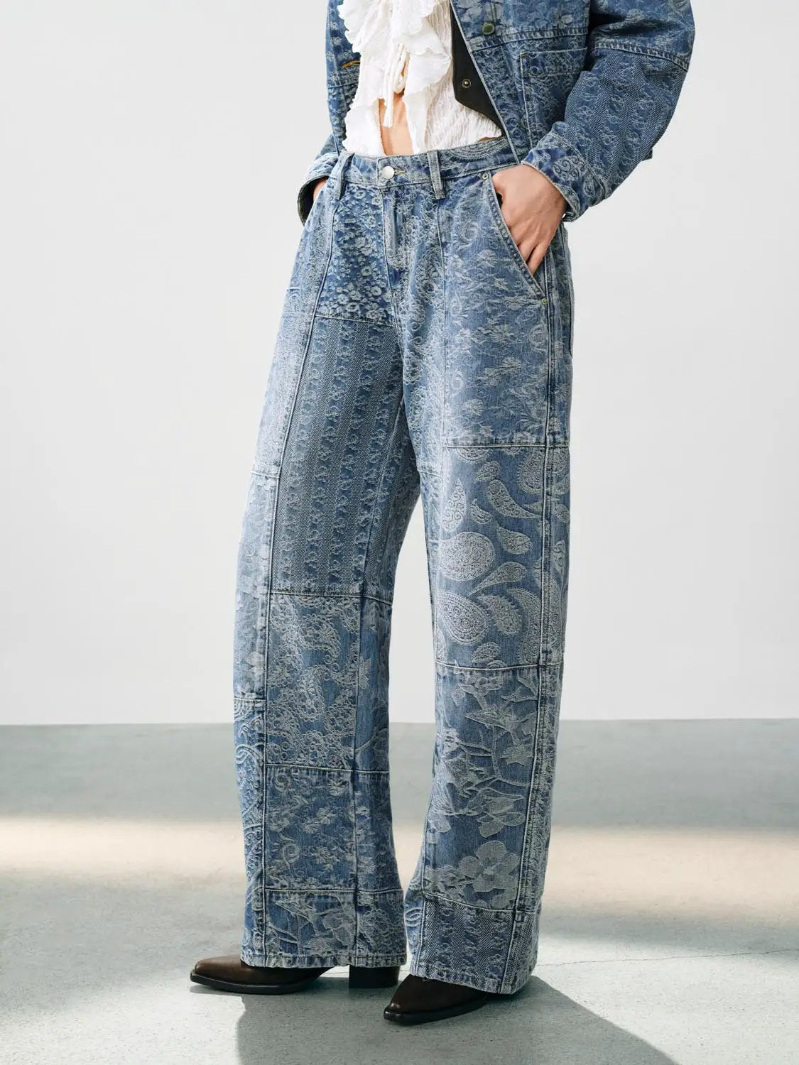 Jeans with blue patchwork jacquard paisley and floral patterns, high-waist wide-leg denim.