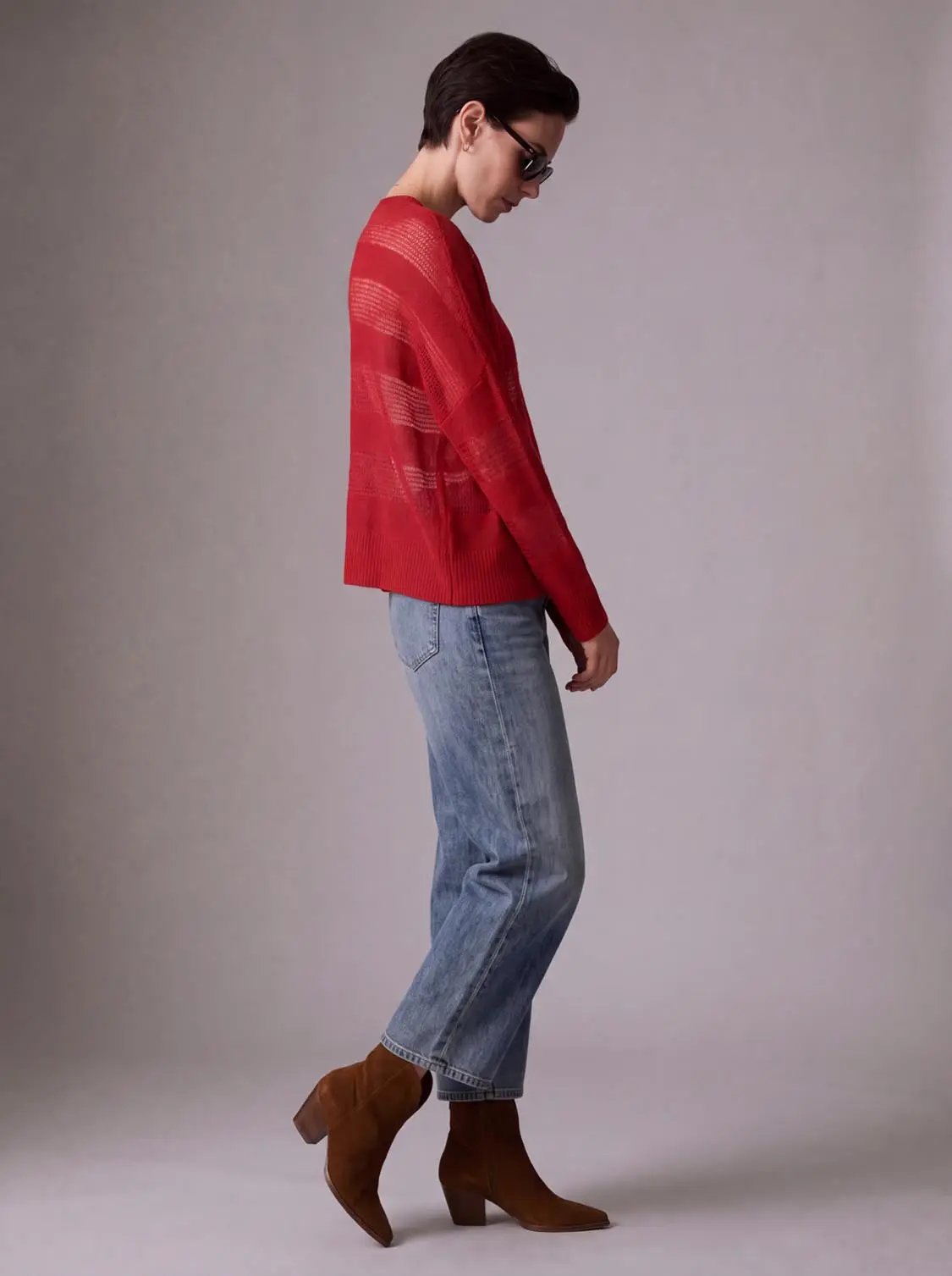 Striped sheer knitted T-shirt in red with translucent stripes, worn with blue jeans