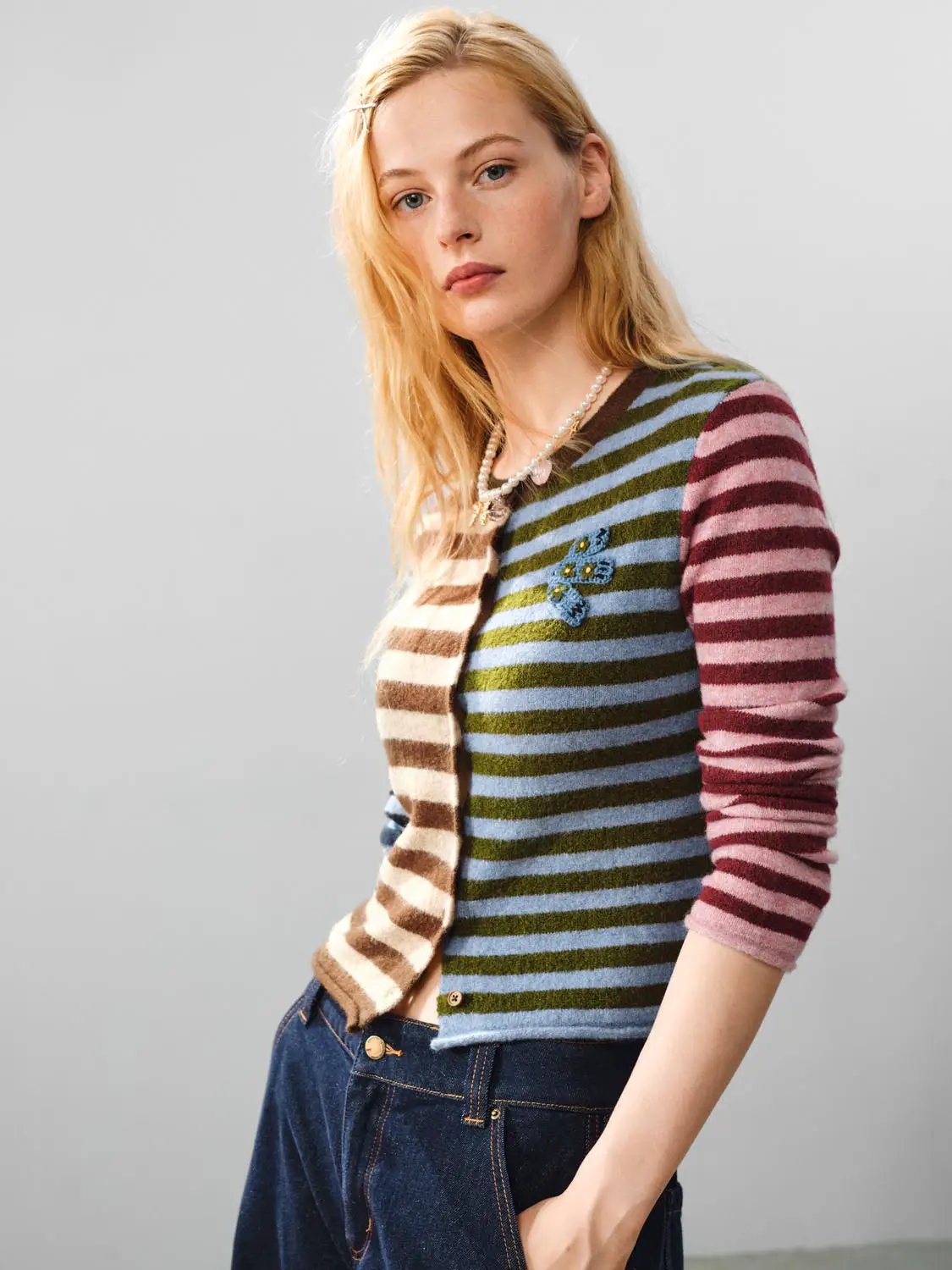 Embroidered striped knit cardigan; multicolor crew neck, long sleeves, blue flower patch, button-front.