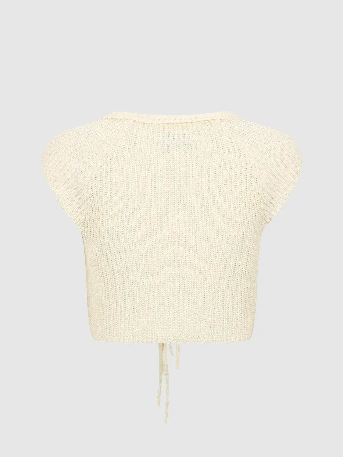 Knit jacket in cream with ribbed knit texture and drawstring hem ties