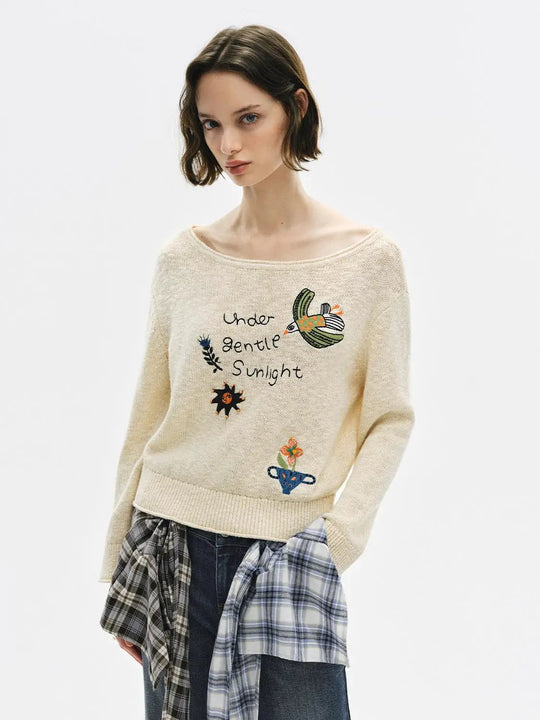 Pull en coton à manches longues avec col bateau et broderie textuelle