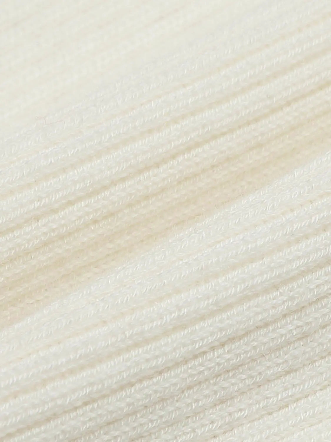 Knit Jacket ivory cream knitted cardigan fabric close-up, showing ribbed texture and soft weave with visible knit lines