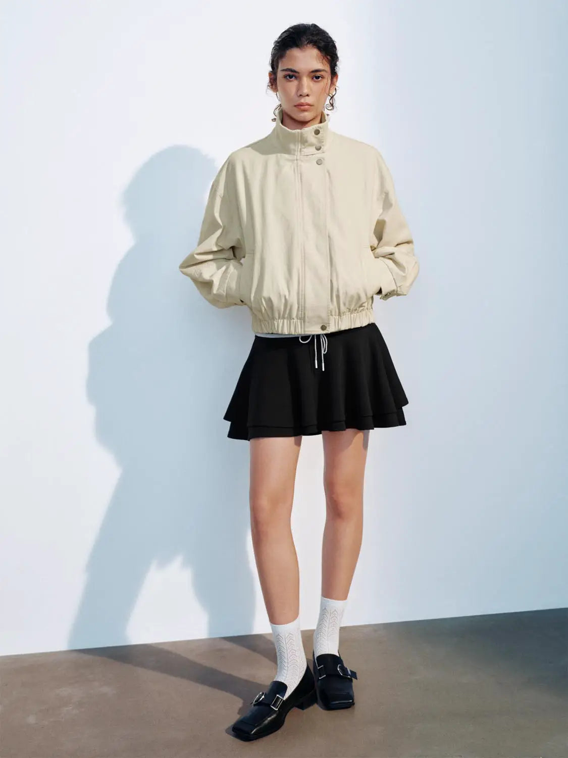 Padded jacket beige by Urban Revivo Fashion; two-piece outfit with a black layered mini skirt