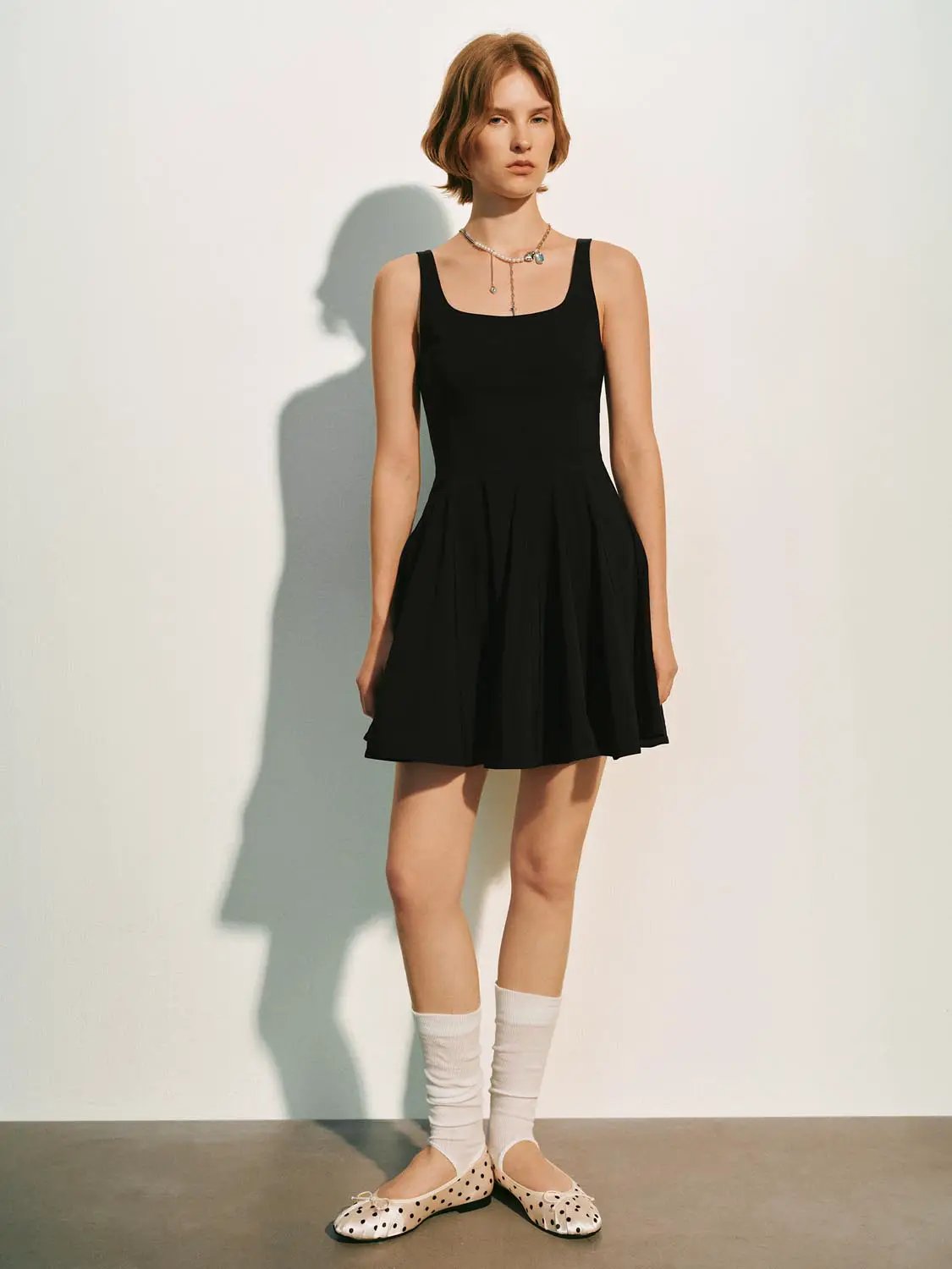 A-line sleeveless square-neck black dress by Urban Revivo Fashion; pleated skirt.
