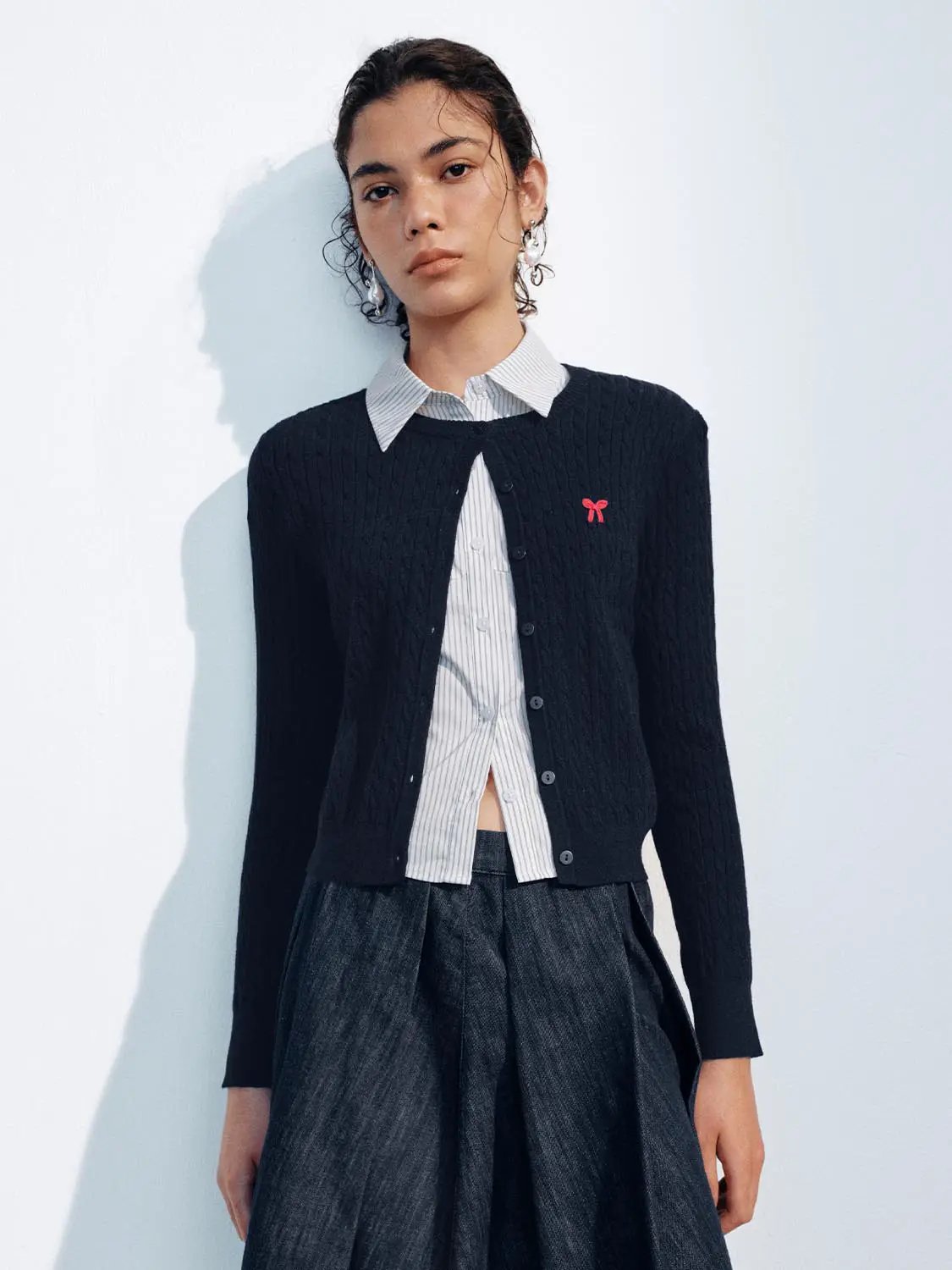 Knit Jacket navy cable-knit cardigan with button front over striped shirt