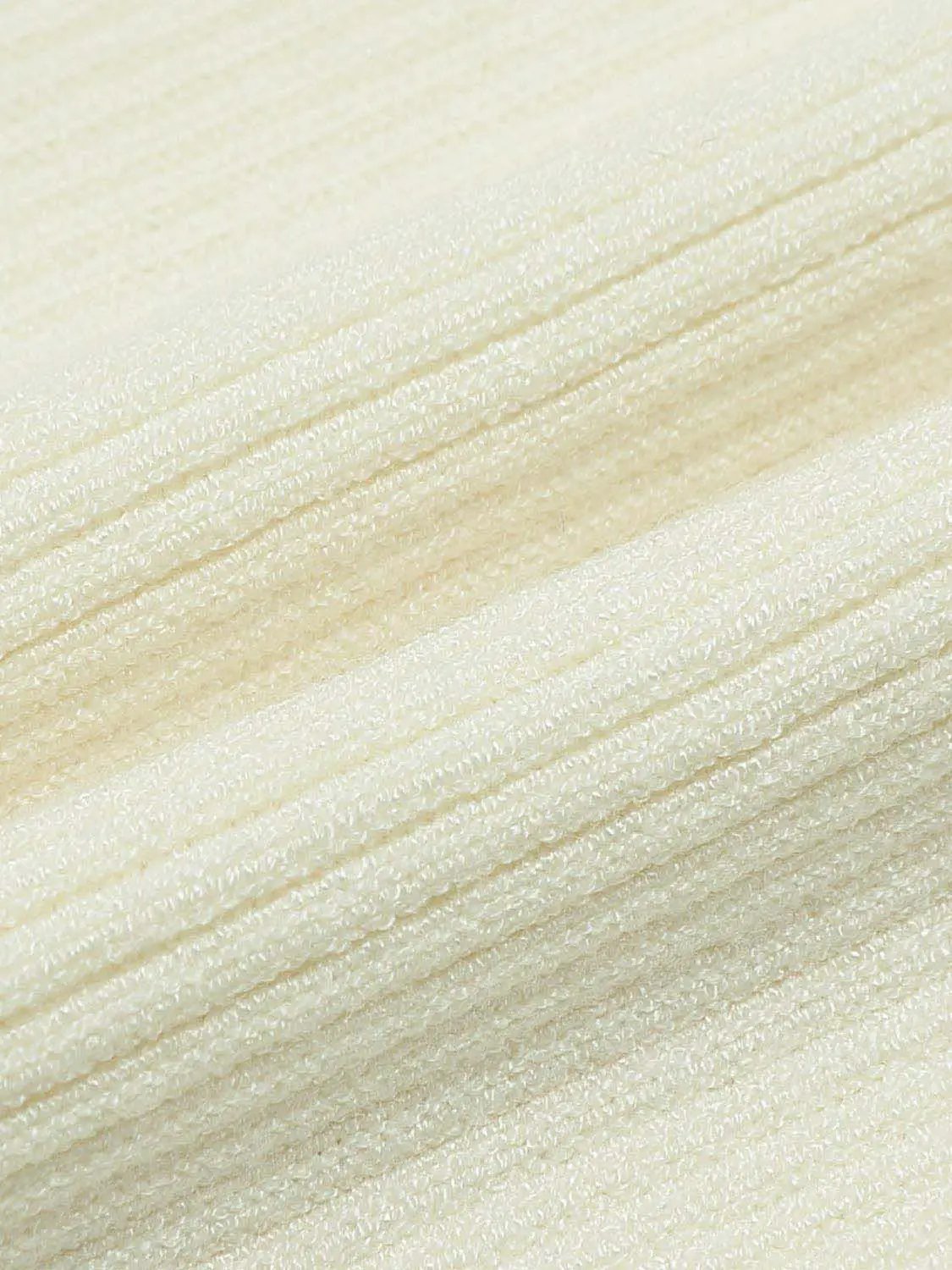 Knitwear blouse fabric close-up in cream with soft knit texture