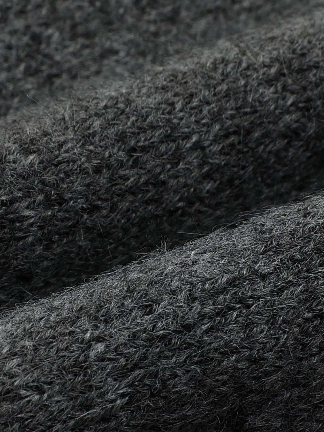 Knitted cardigan by Urban Revivo Fashion in charcoal gray; close-up of soft textured knit fabric