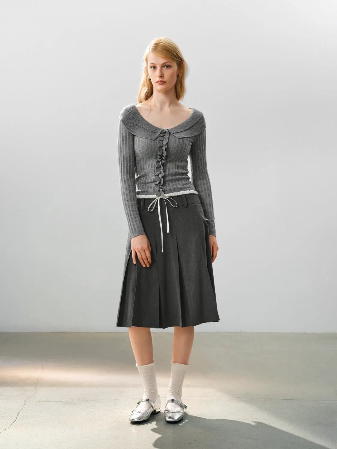 Knitted T-shirts gray ribbed knit top with wide collar and front ruffles, paired with a gray midi skirt.