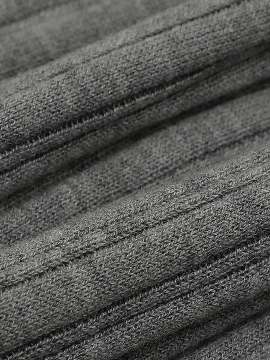 Knitted T-Shirts fabric in grey heather knit, close-up texture with fine interlock stitches.