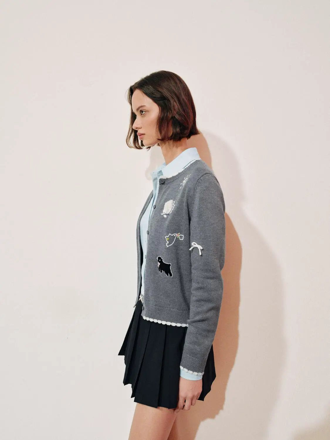 Graphic long sleeve ribbed knit cardigan with embroidered patches, gray with white trims