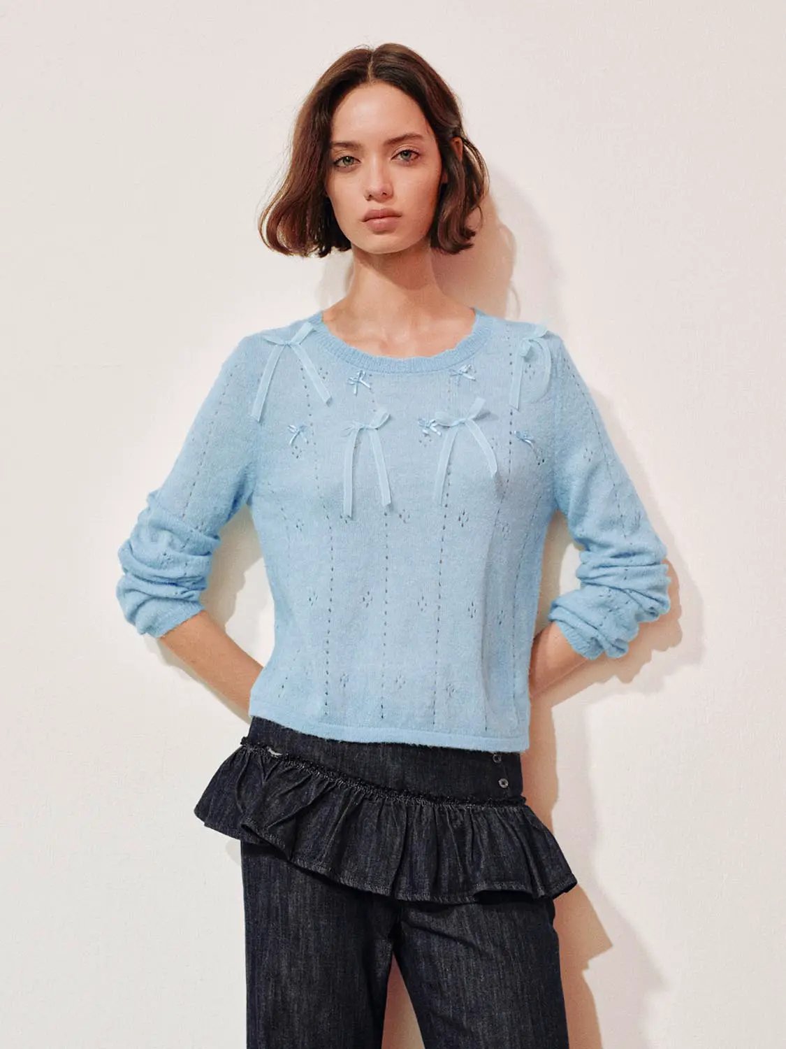 Bow-detail textured crew-neck long-sleeve sweater in light blue knit with front bows.