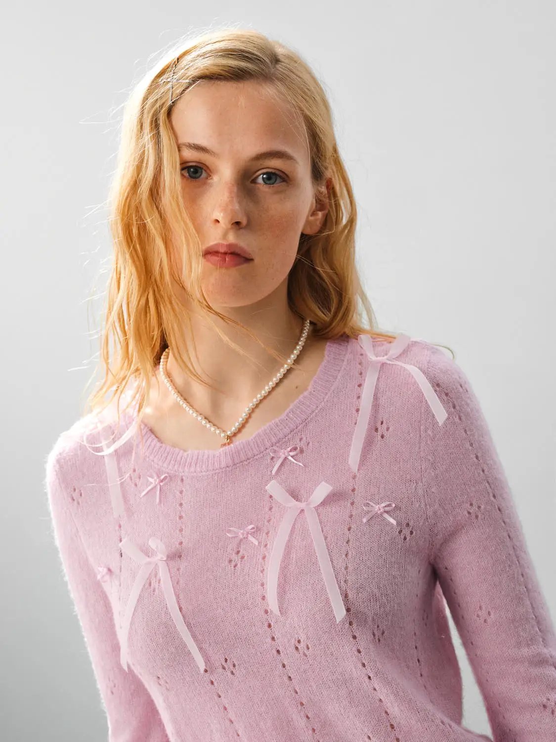 Bow-detail textured crew-neck long-sleeve sweater in pink with ribbon accents